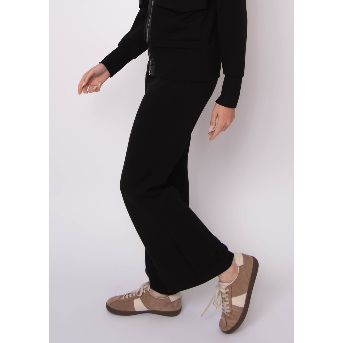 Florine Soft Knit Pull-On Flare Pants with a close-fitting leg that flares at the hem, paired with tan sneakers.