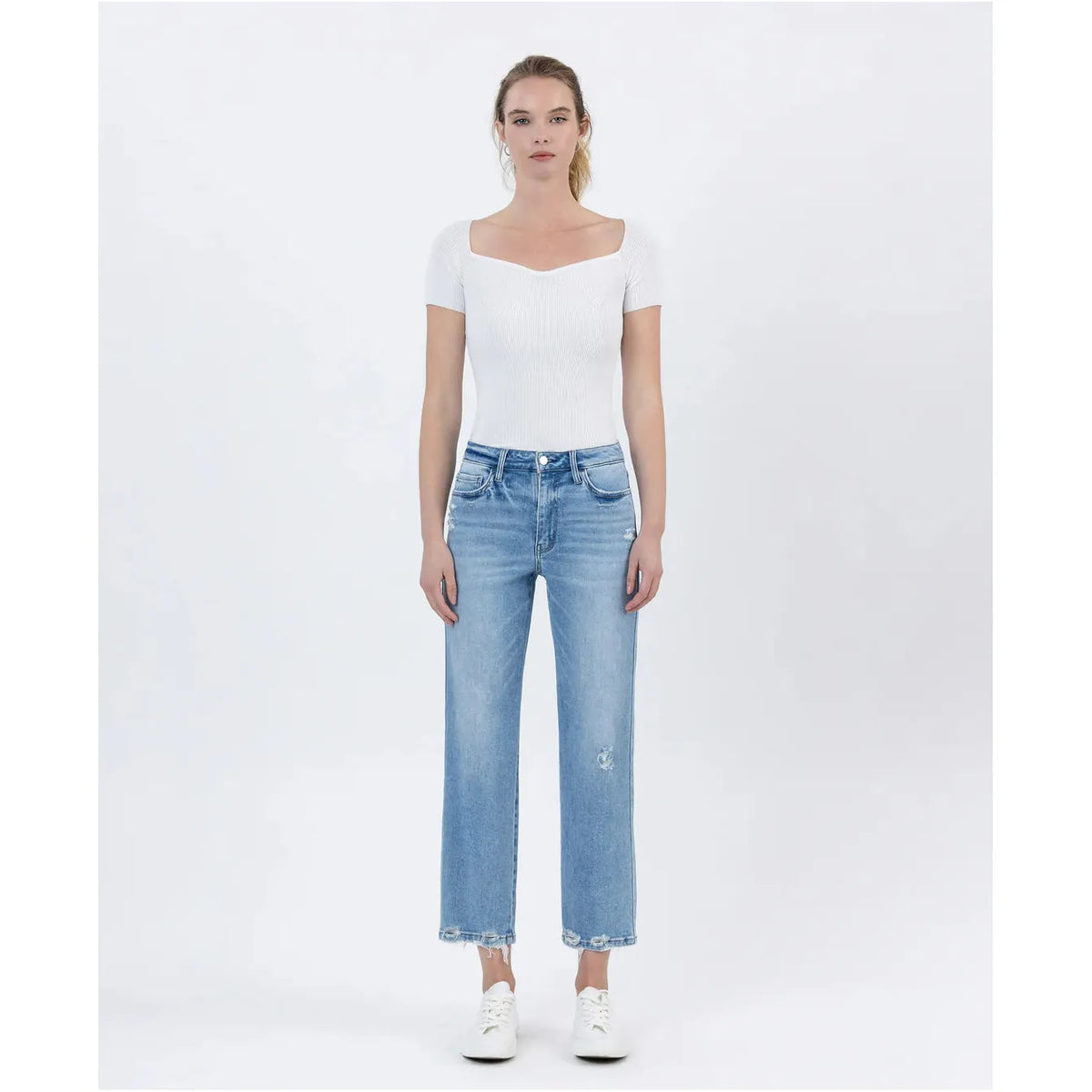 Stylish model showcasing the Flying Monkey Boatload High Rise Straight Crop Distressed Hem jeans with a trendy look.