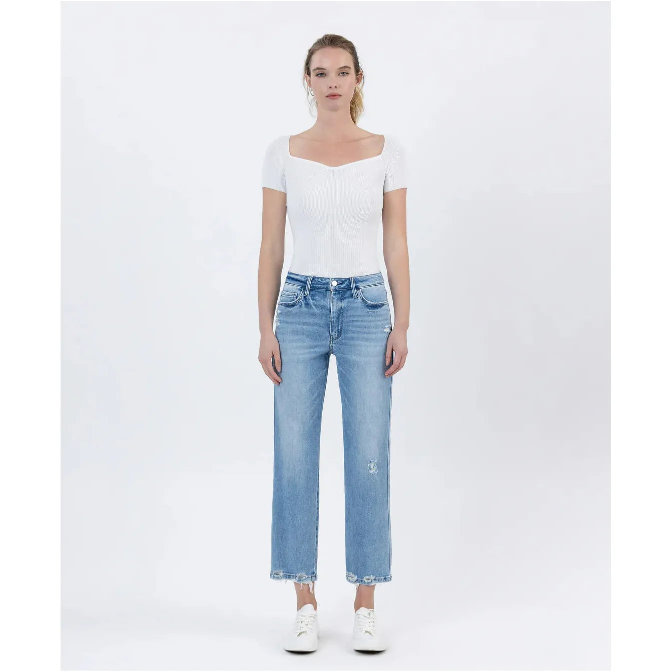 Stylish model showcasing the Flying Monkey Boatload High Rise Straight Crop Distressed Hem jeans with a trendy look.