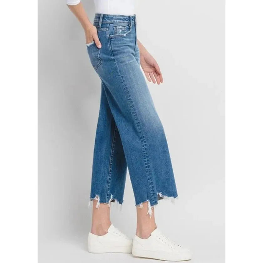 Stylish model showcasing Flying Monkey Delightful High Rise Crop Wide Leg Denim with a distressed hem and medium wash.