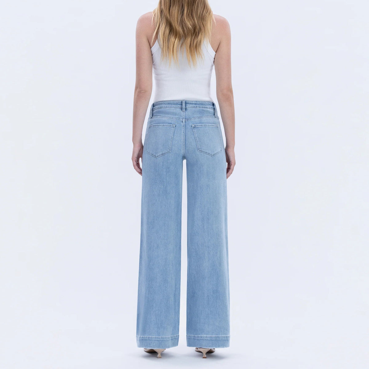 Flying Monkey Dignity high-rise patch-pocket wide-leg denim trousers worn by model, back view in light wash.