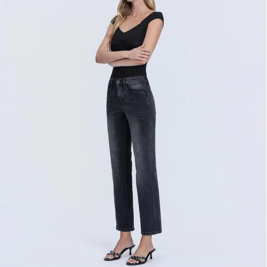 Dark washed high rise ankle straight jeans with a flattering fit, shown on a model wearing a black top and heeled sandals.