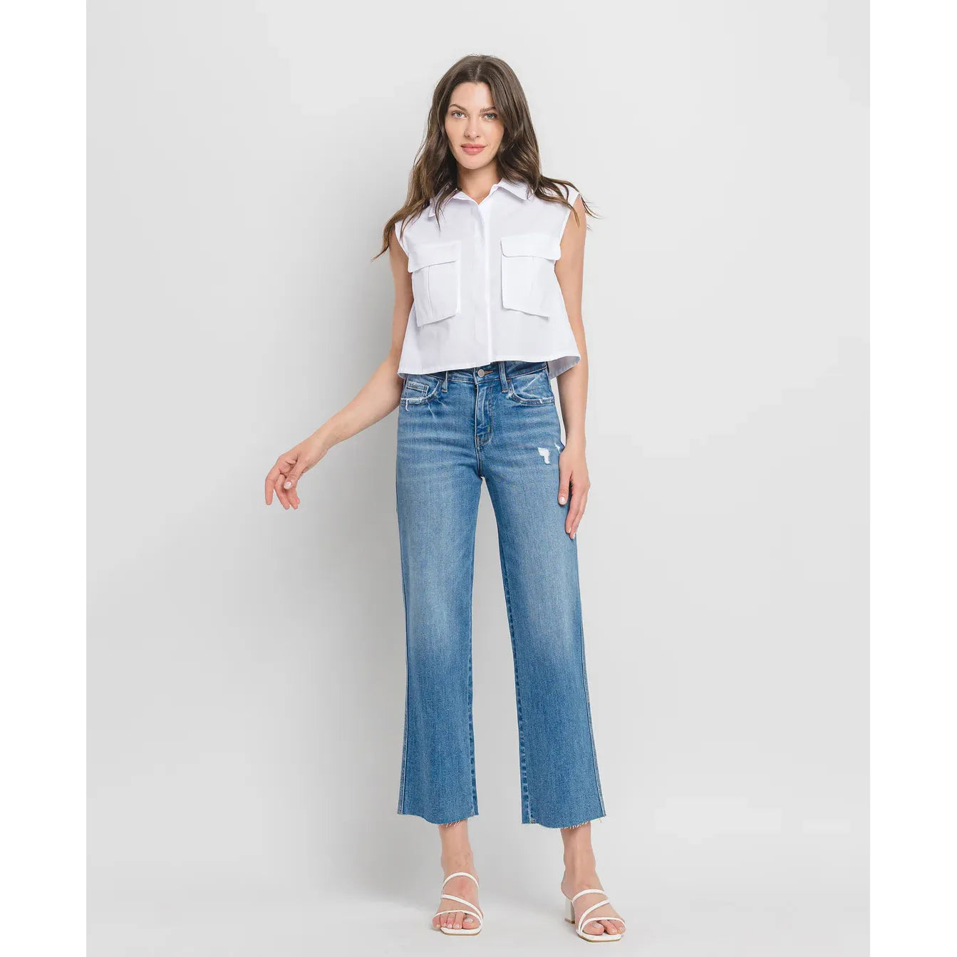 Flying Monkey supported high-rise slim wide-leg jeans with distressing and raw hem; model wearing white top