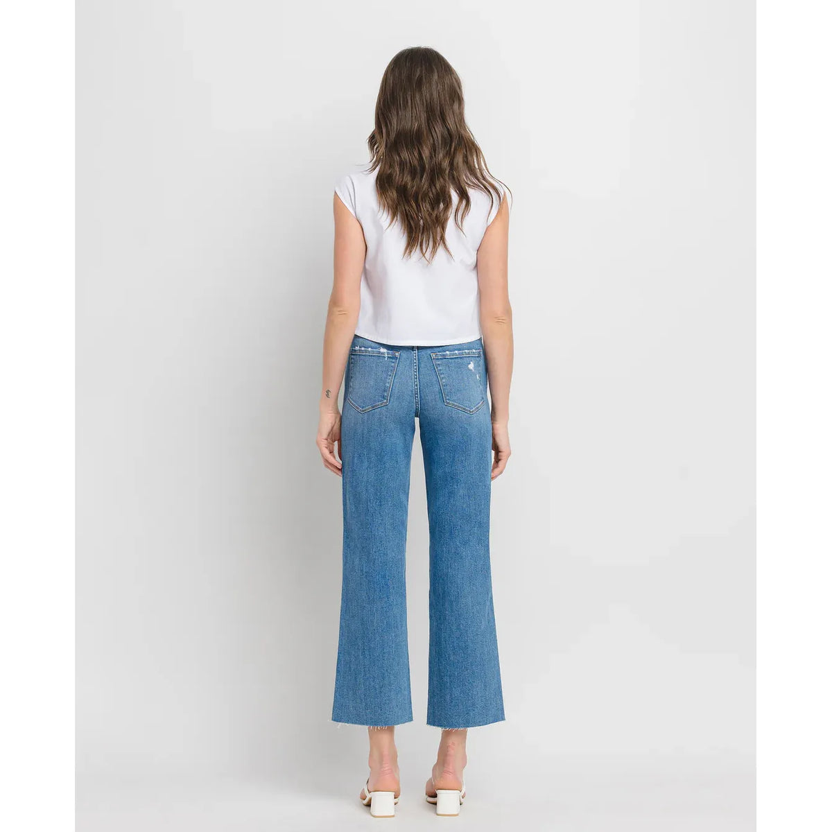 Flying Monkey supported high-rise slim wide-leg jeans with raw hem, distressed blue denim, back pockets.