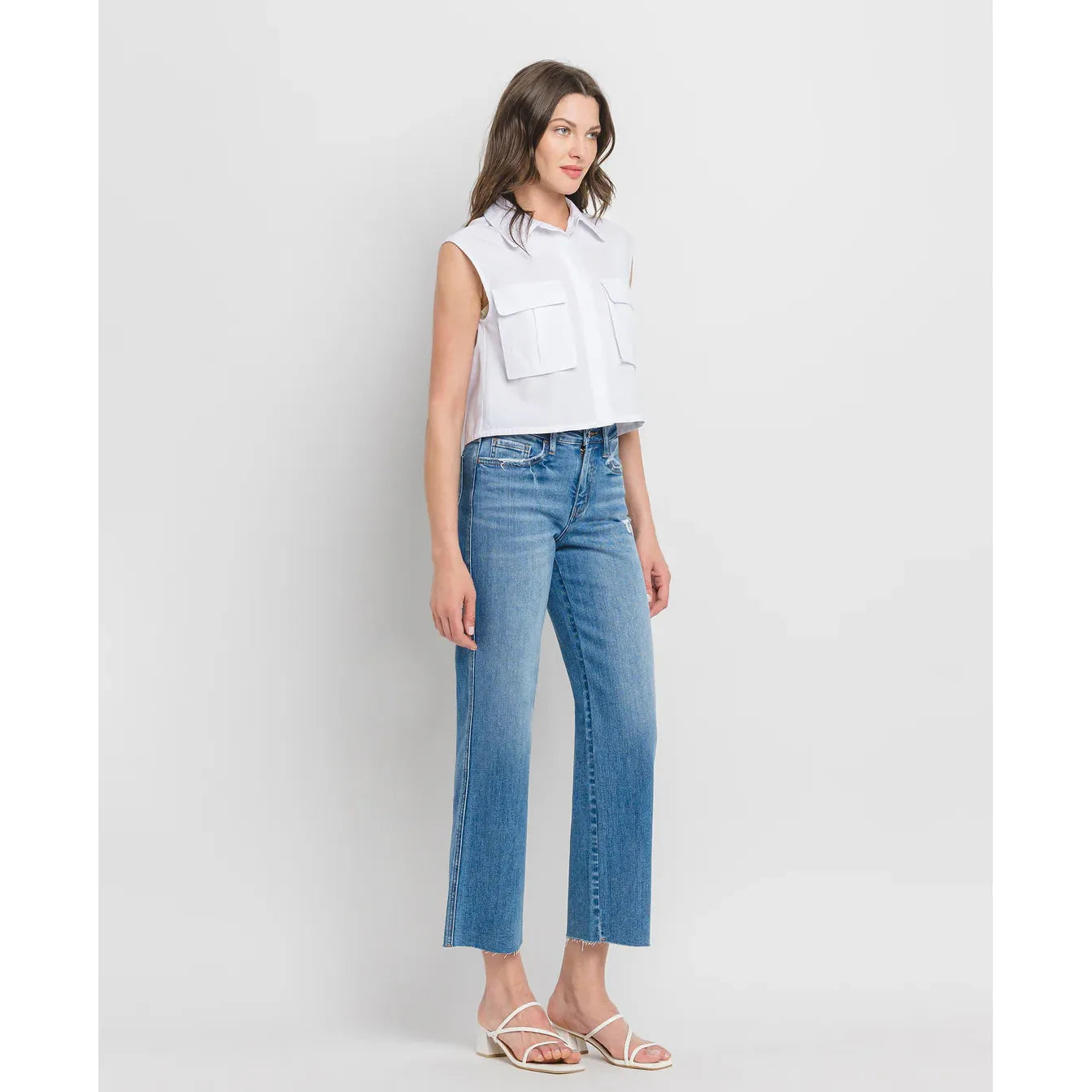 Flying Monkey supported high-rise slim wide-leg denim jeans in light wash with distressed raw hem.