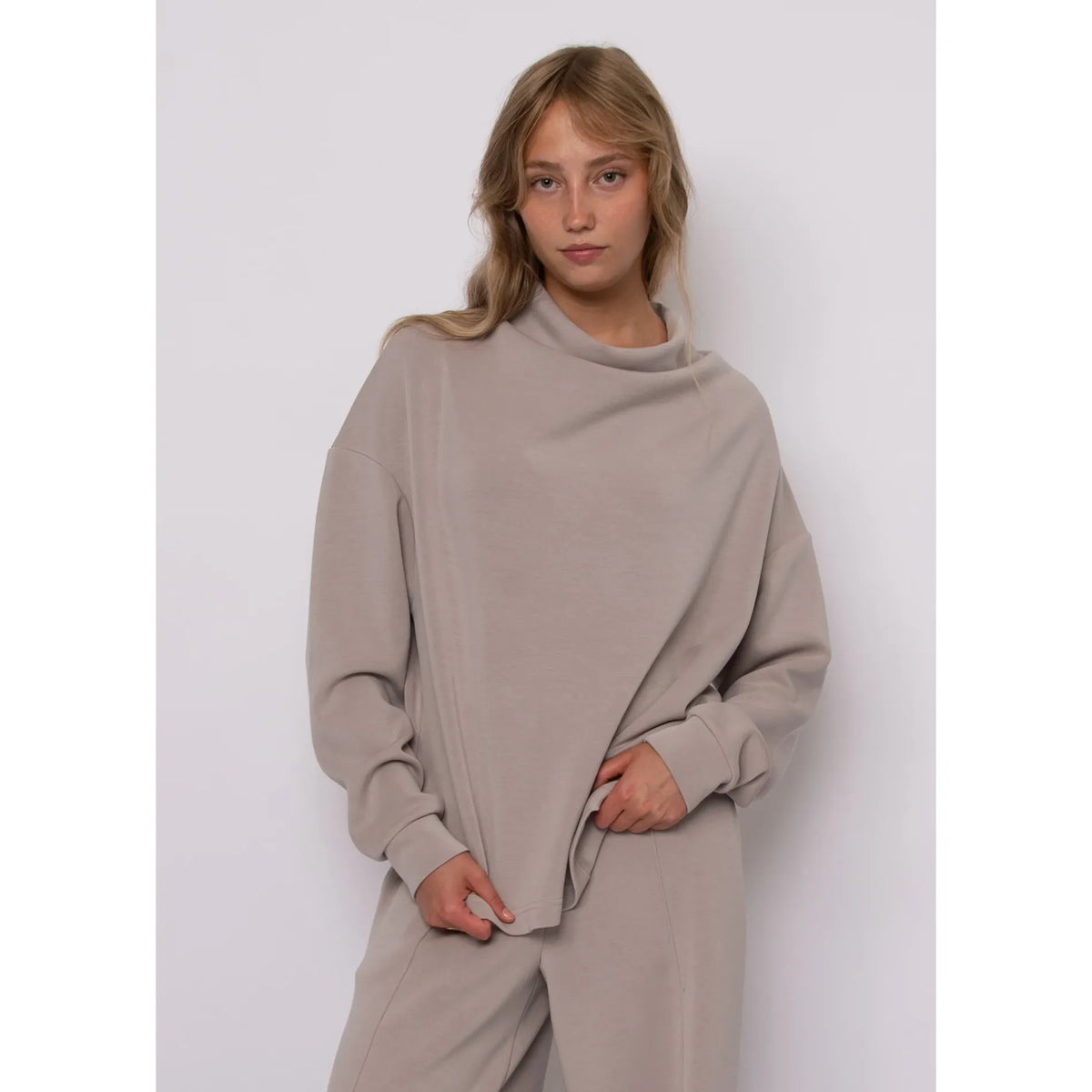 Beige soft knit funnel neck top with long sleeves and relaxed fit for effortless everyday comfort and style.