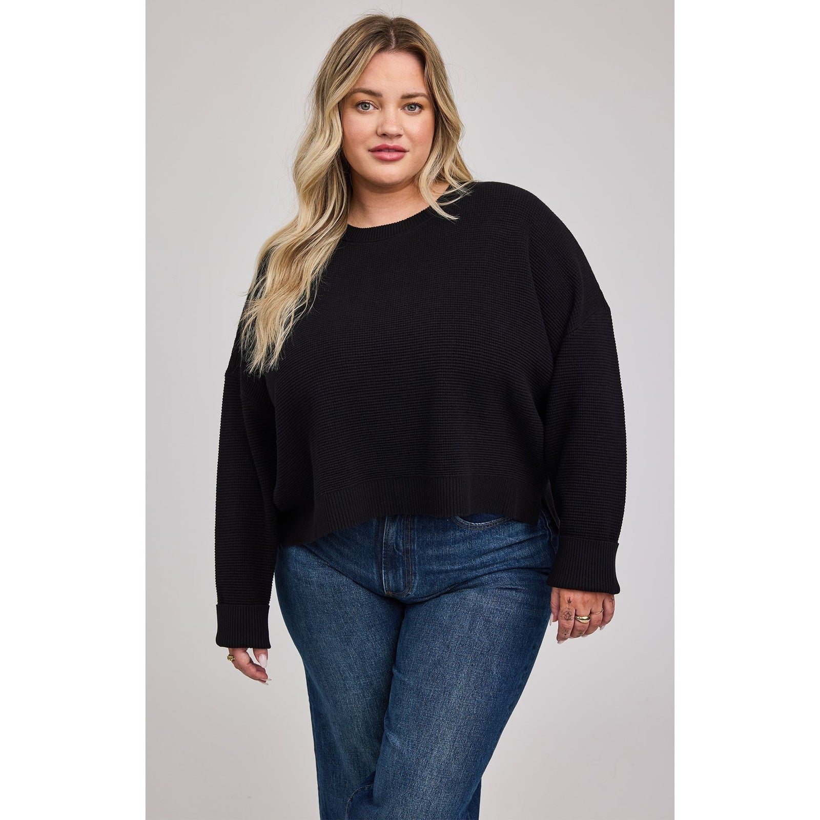 Gentle Fawn Axel Crewneck Sweater on a model in black knit, oversized with side slits.