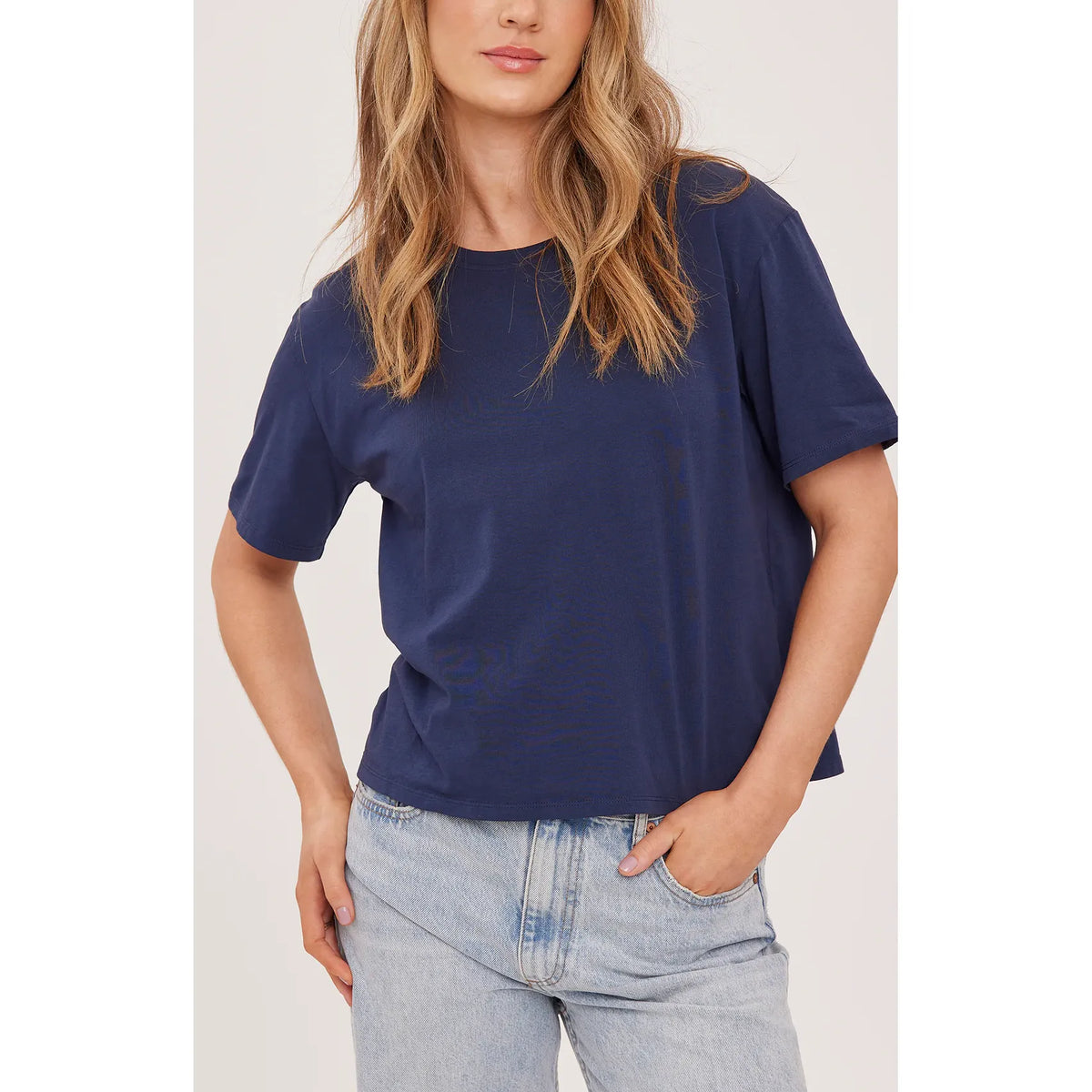 Navy Gentle Fawn Brigitte Tshirt with a relaxed crew neck on a model, paired with light denim.
