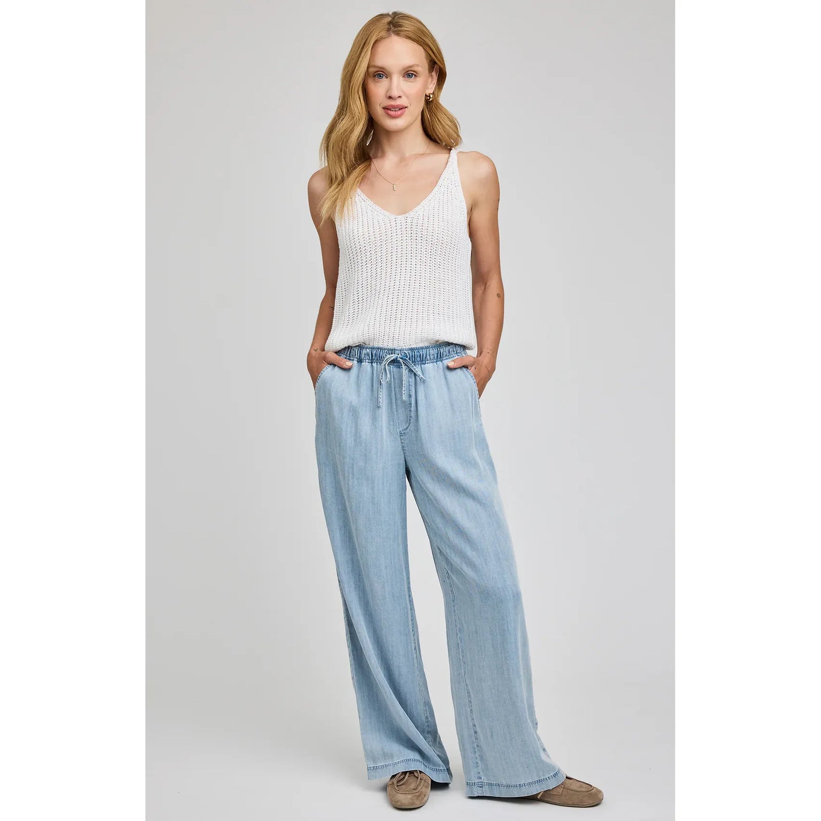 Gentle Fawn Camille Pant: light-wash wide-leg pants with elastic drawcord waist and slash pockets on a model.
