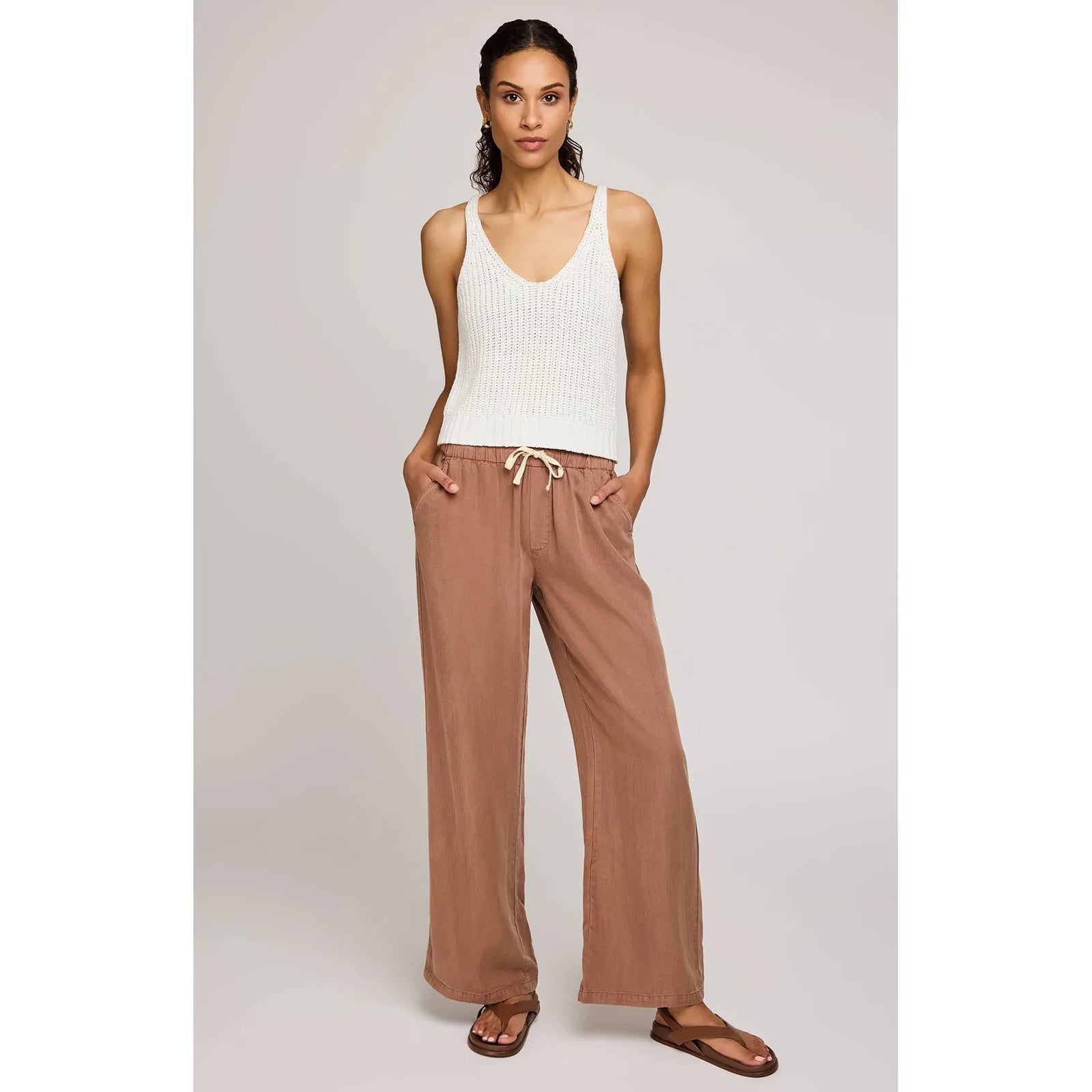 Stylish model wearing Gentle Fawn Elio Pant in desert color, featuring soft Tencel fabric and comfy elastic waistband.