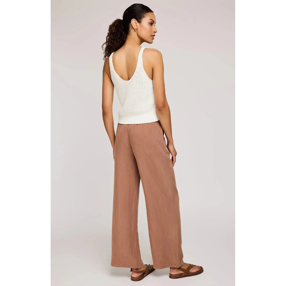 Stylish woman wearing Gentle Fawn Elio Pant, featuring soft Tencel fabric and comfortable elastic waistband.