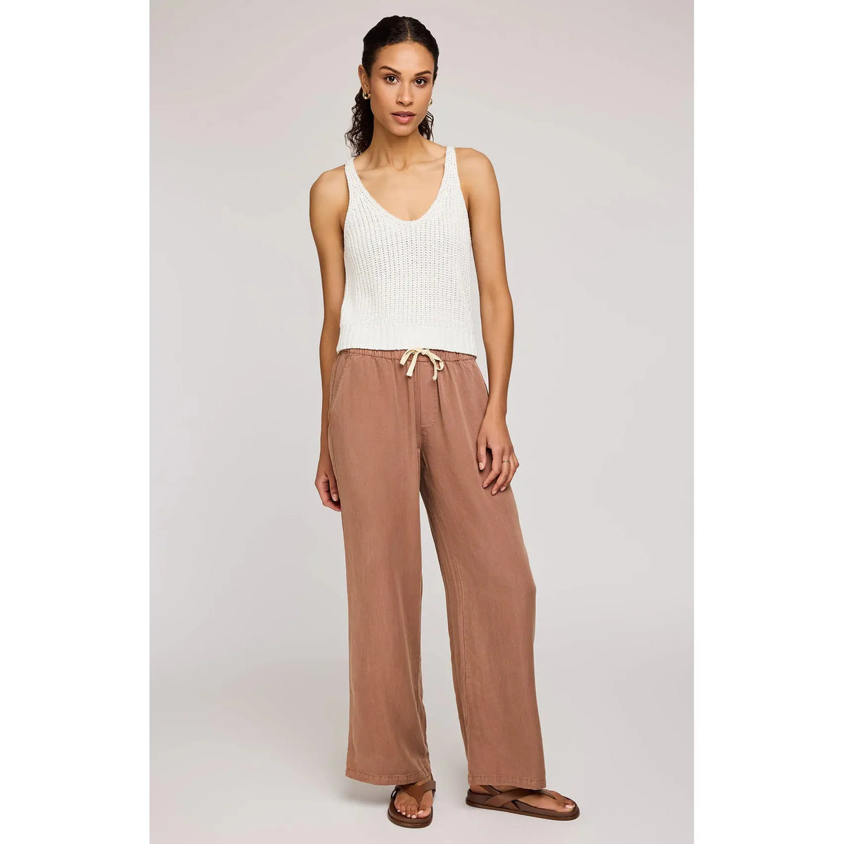 Stylish model wearing Gentle Fawn Elio Pant in desert color, showcasing its comfortable design and soft Tencel fabric.