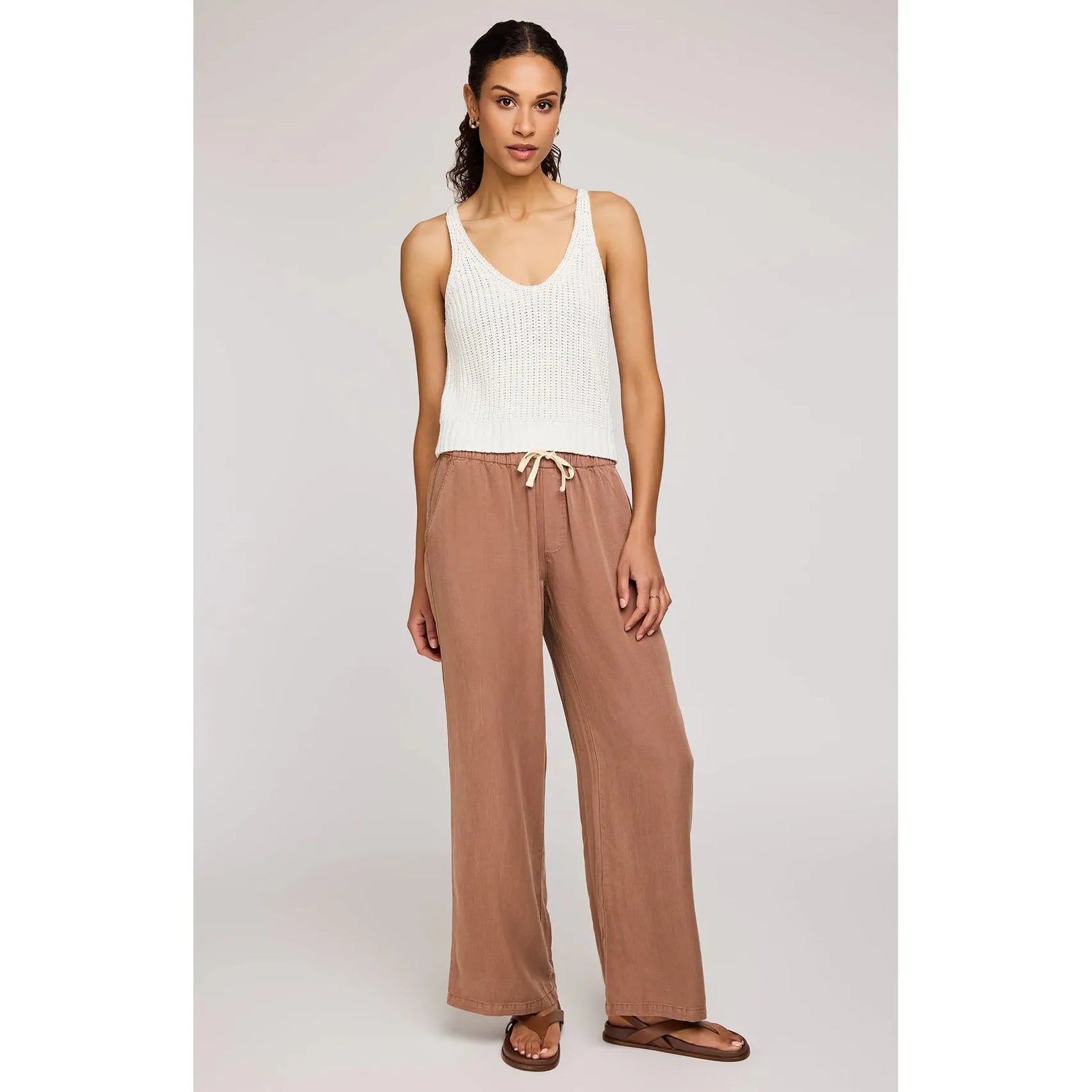 Stylish model wearing Gentle Fawn Elio Pant in desert color, showcasing its comfortable design and soft Tencel fabric.