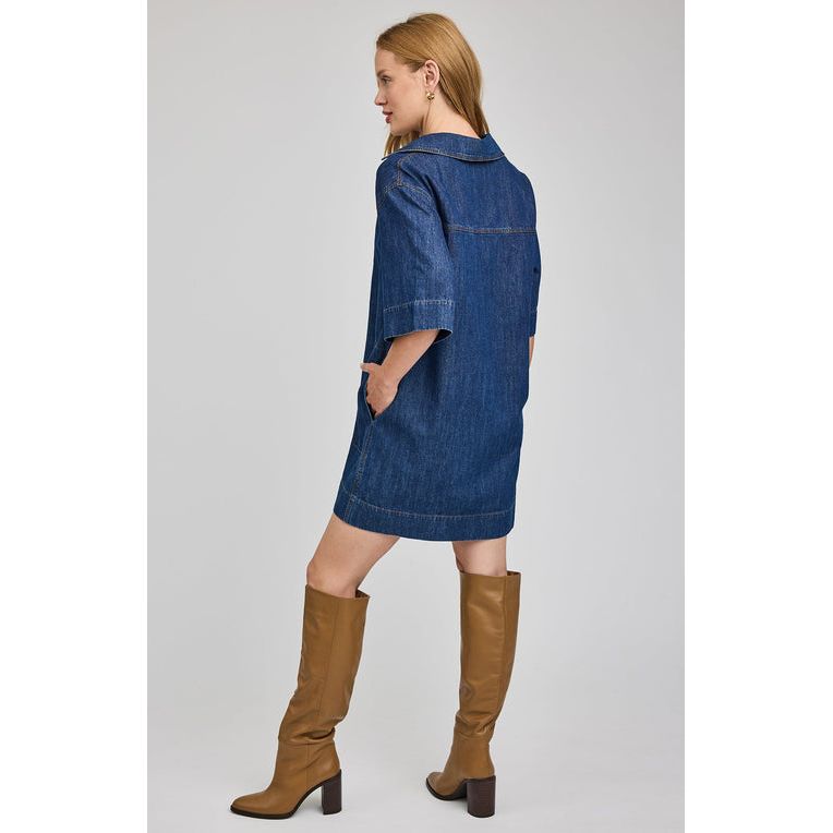Gentle Fawn Evelina Denim Mini Dress on model: washed denim, V-neck collar, short sleeves, mini length, tan boots.