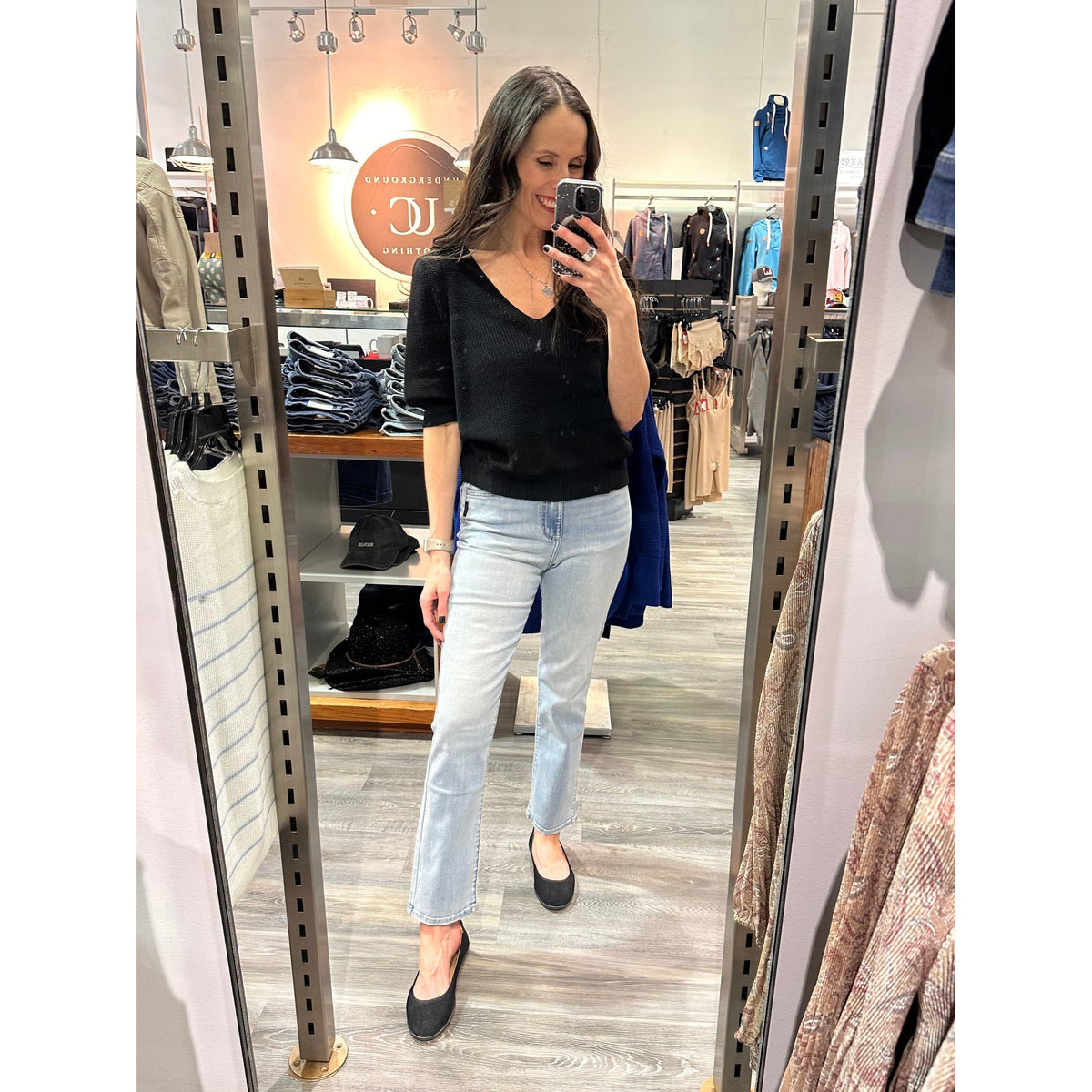 Gentle Fawn Phoebe V-Neck Sweater in black knit with puff sleeves, showcased in store.