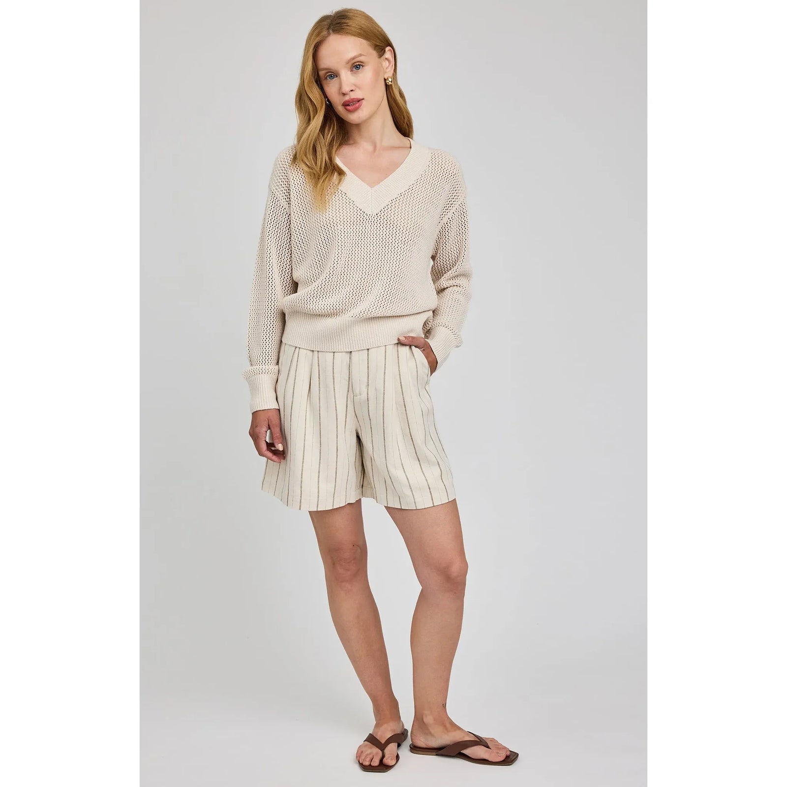 Gentle Fawn Jensen V-Neck Pullover in beige with open-knit texture and wide rib V-neck on a model.