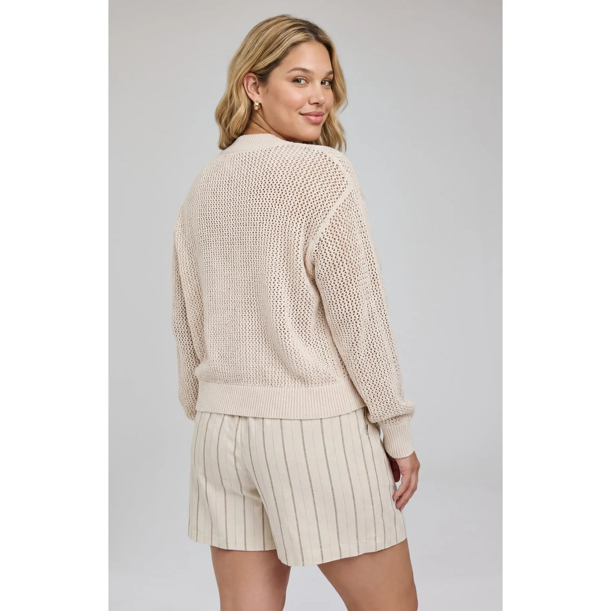 Gentle Fawn Jensen V-Neck Pullover on a model, beige open-knit sweater with a wide ribbed V-neck