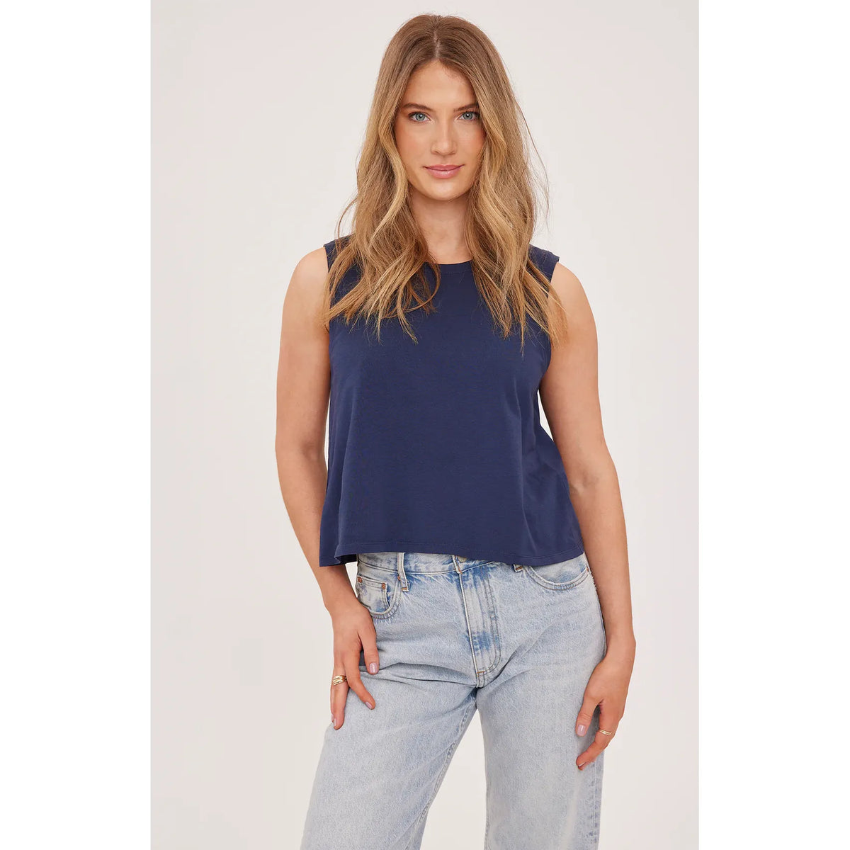 Navy Kate Tank from Gentle Fawn, garment-dyed cotton jersey, relaxed sleeveless top on model with light denim.