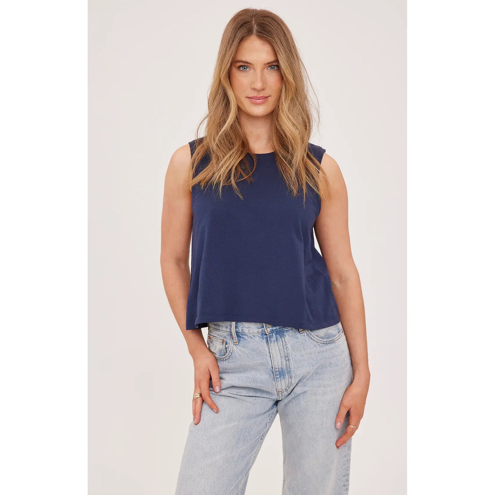 Navy Kate Tank from Gentle Fawn, garment-dyed cotton jersey, relaxed sleeveless top on model with light denim.