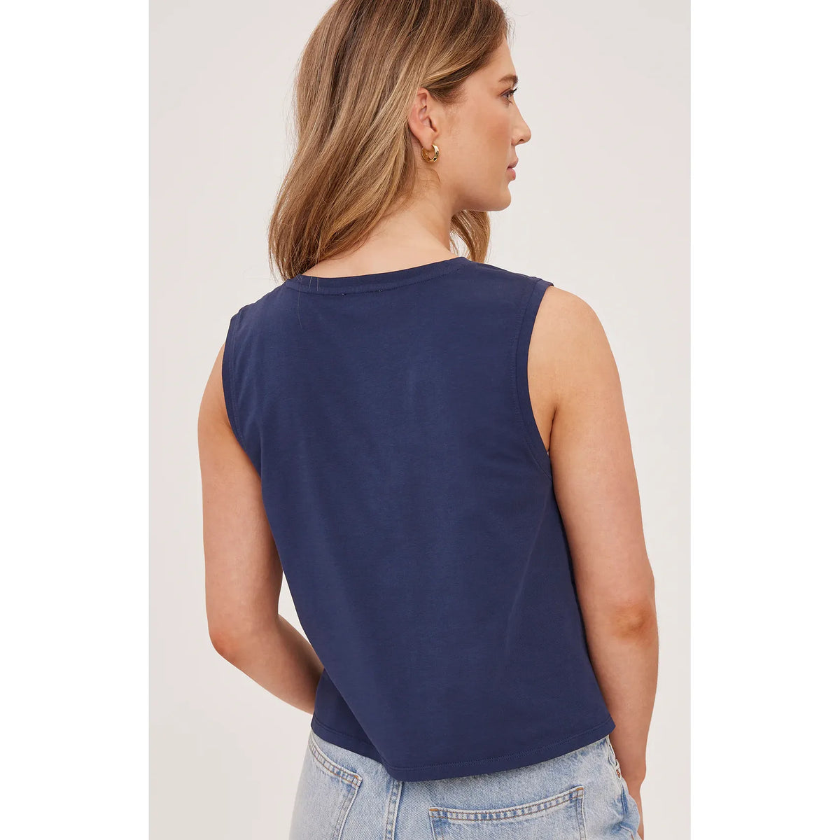 Back view of a model wearing navy Gentle Fawn Kate Tank, sleeveless cotton jersey top.