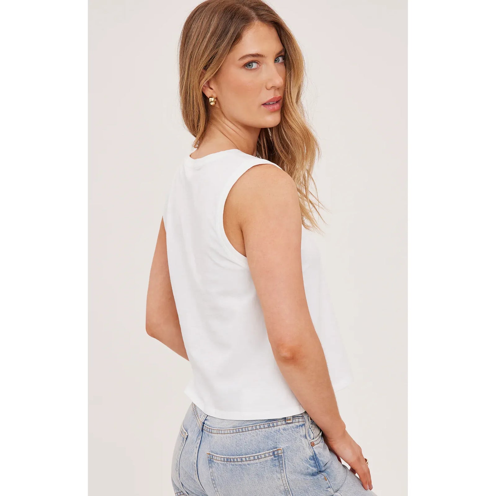 Navy Kate Tank from Gentle Fawn, garment-dyed cotton jersey, relaxed sleeveless top on model with light denim.