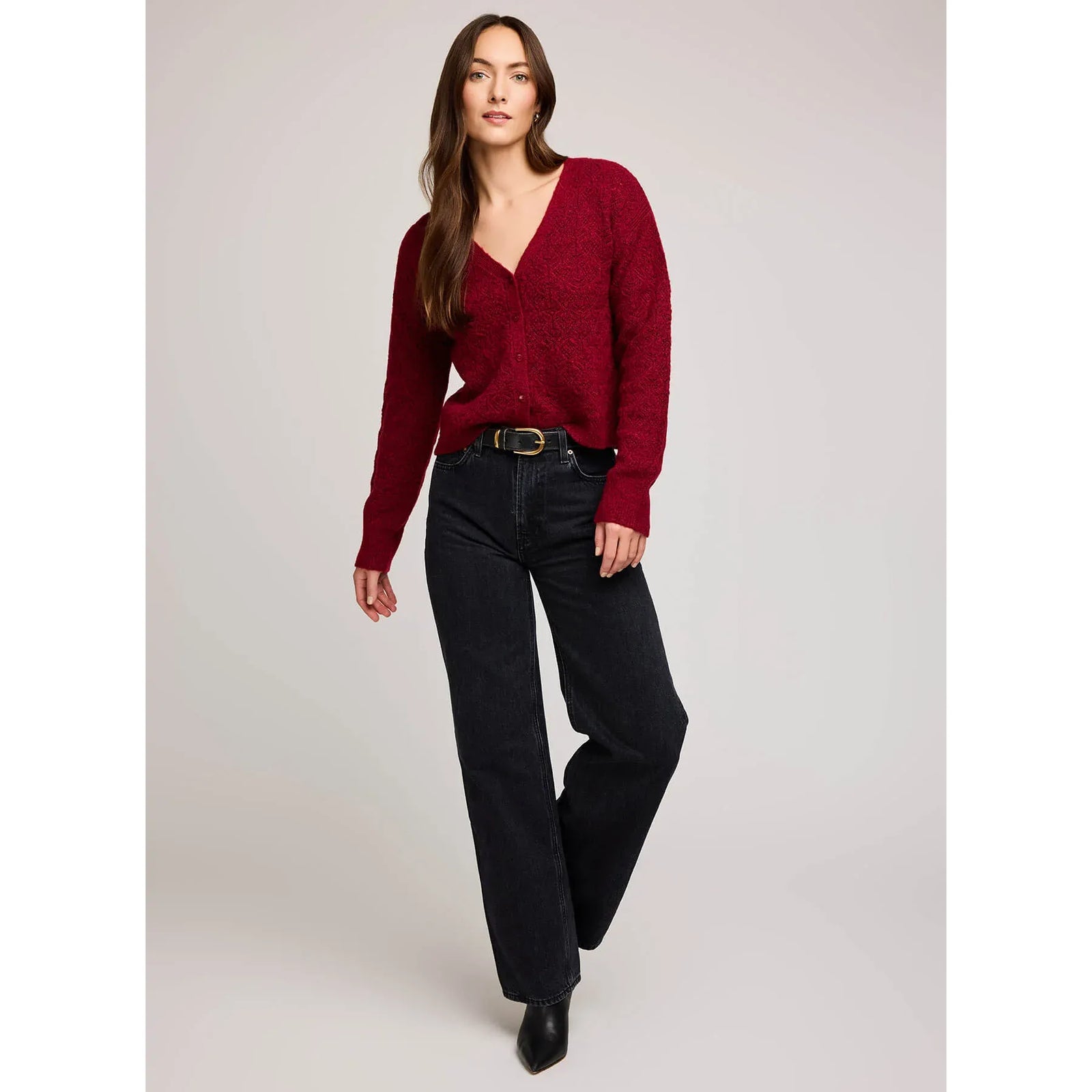 Model wearing burgundy Gentle Fawn Lila Cardigan with V-neck and button front, paired with dark jeans.