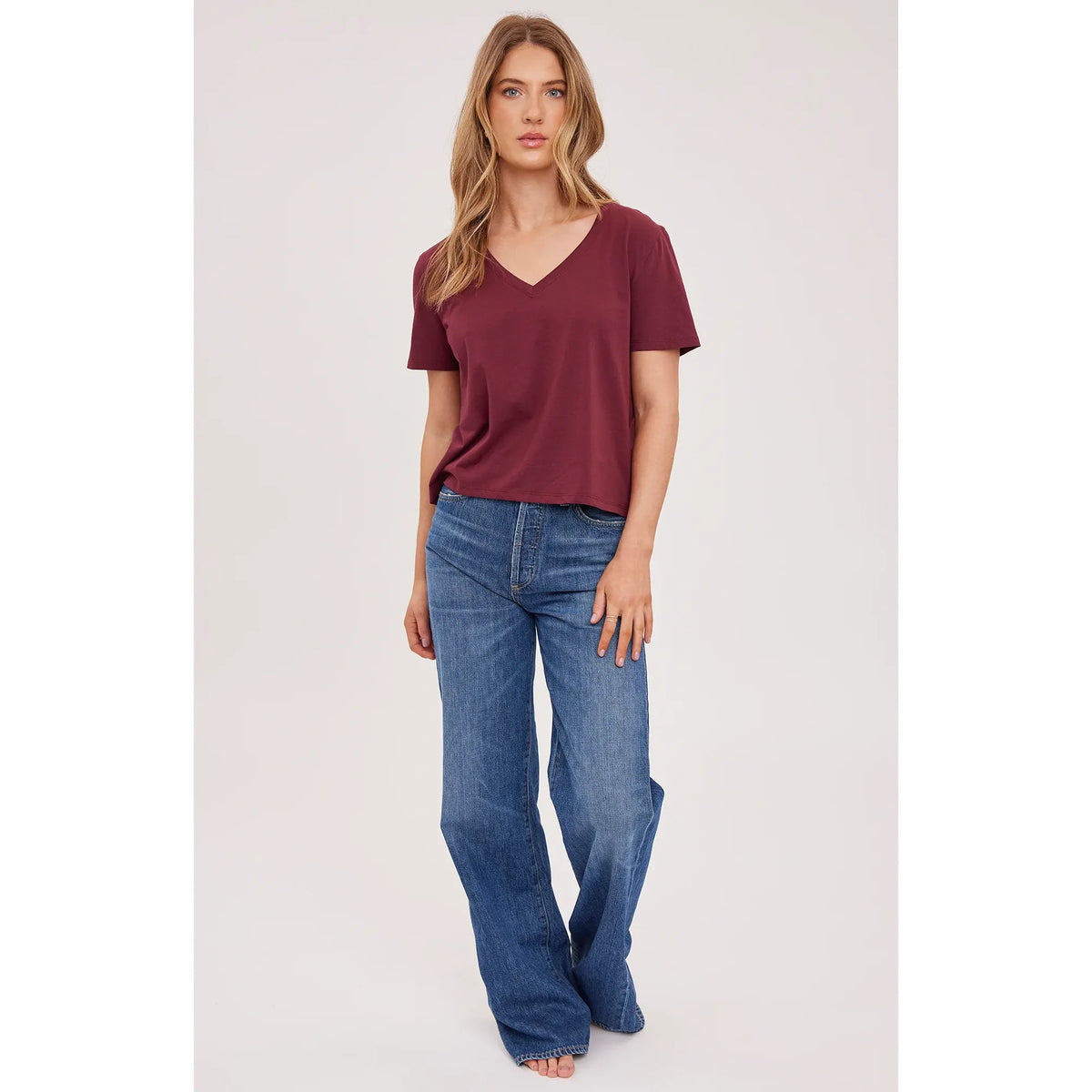 Maroon cotton V-neck cropped top paired with blue jeans for a casual everyday look.