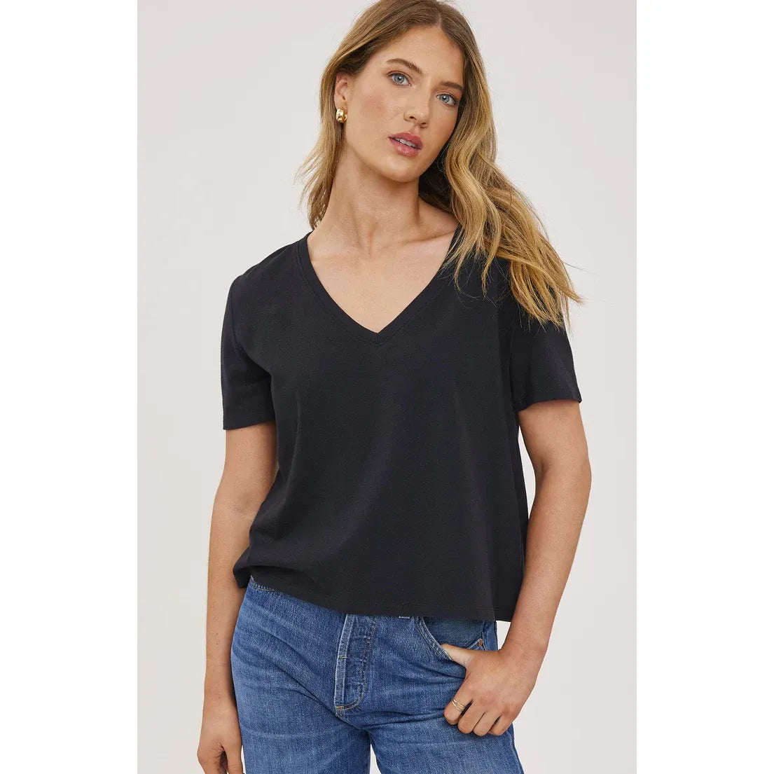 Gentle Fawn Lucy Top, black 100% cotton, V-neck, short-sleeve shirt worn with jeans.