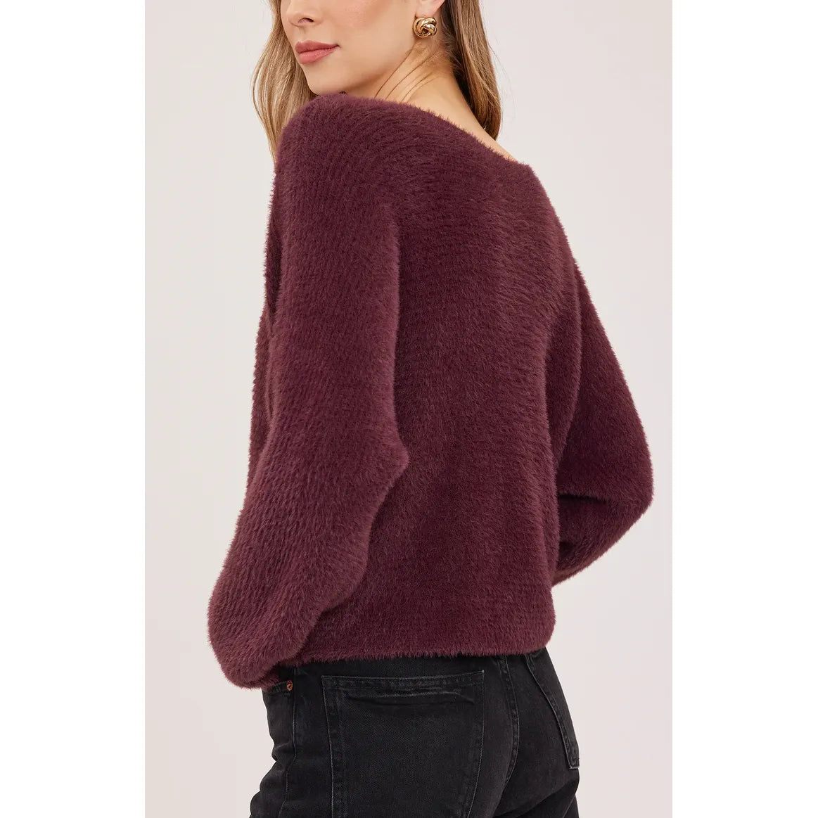 Plush deep port maroon sweater featuring dolman sleeves and a wide boat neckline. Chunky knit pullover styled with dark denim.