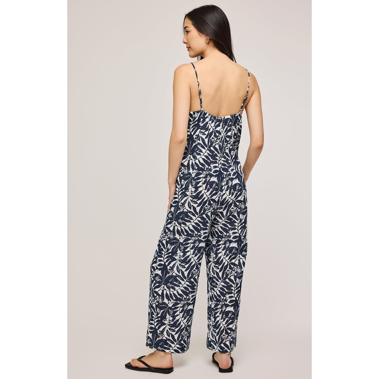 Stylish woman wearing the Gentle Fawn Matilda Jumpsuit, featuring adjustable straps and a chic wide leg design.