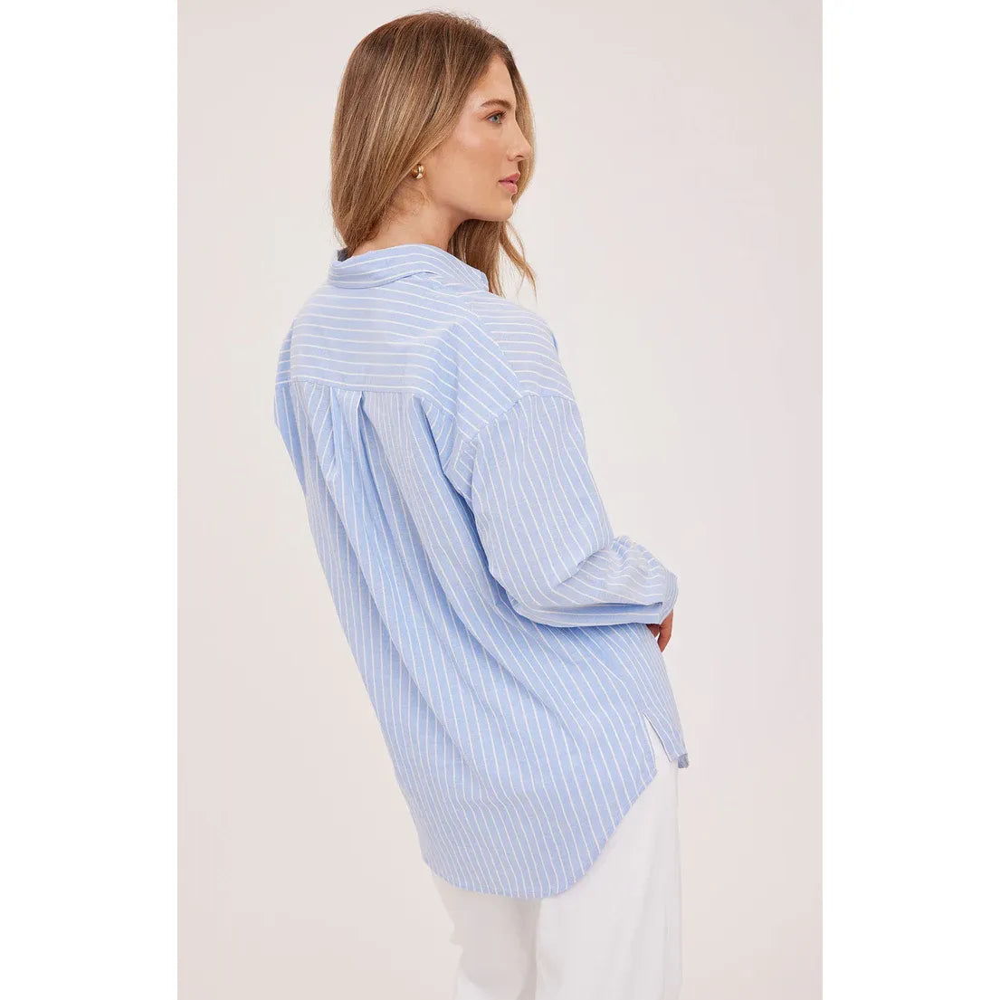 Gentle Fawn Orlando Button Down Shirt in light blue stripes worn by a model, relaxed fit, back view.