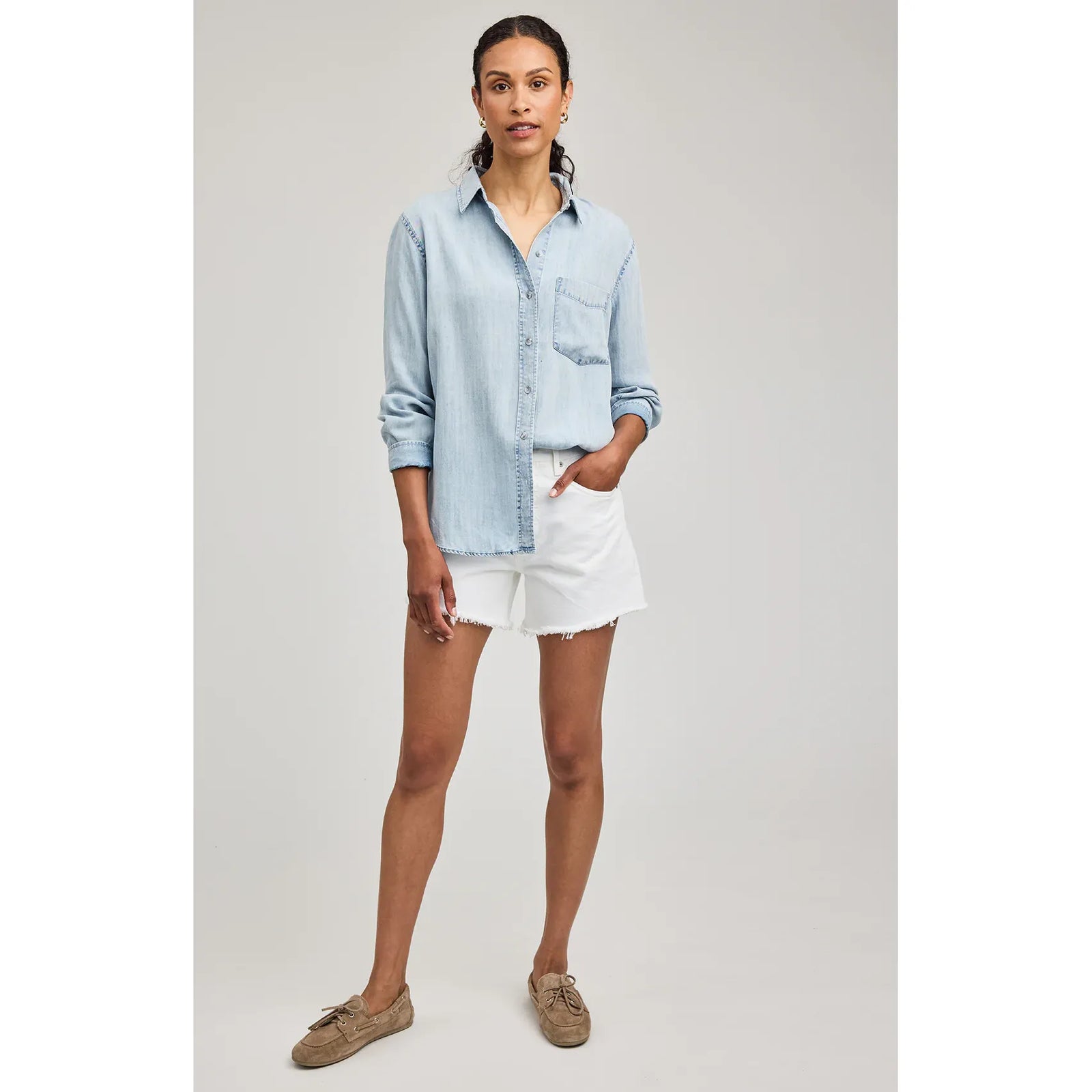 Model wearing Gentle Fawn Ozzy Button Down Shirt in 100% Tencel with a washed finish, paired with white shorts.