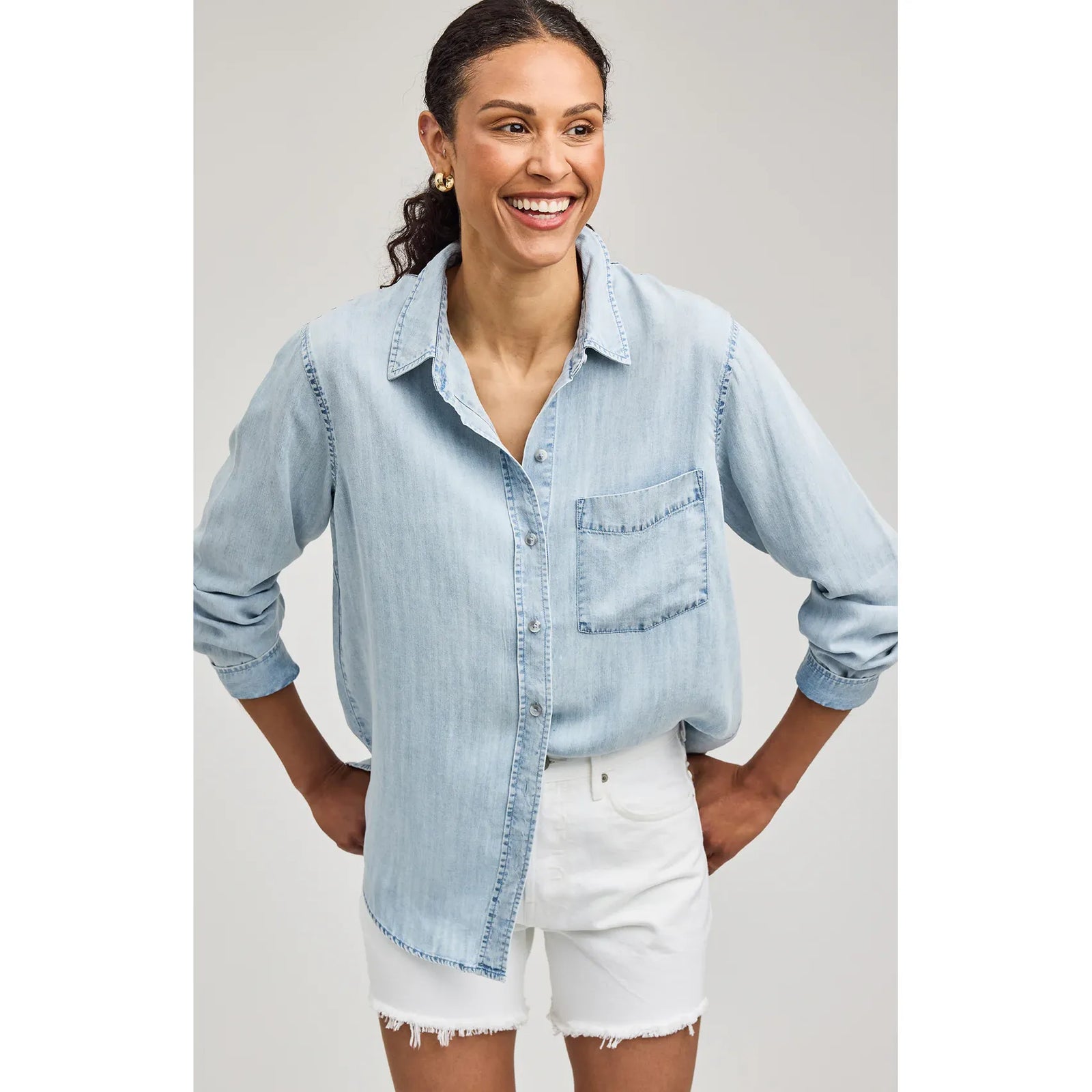Gentle Fawn Ozzy Button Down Shirt, 100% Tencel with a washed finish, light denim on a model paired with white shorts.