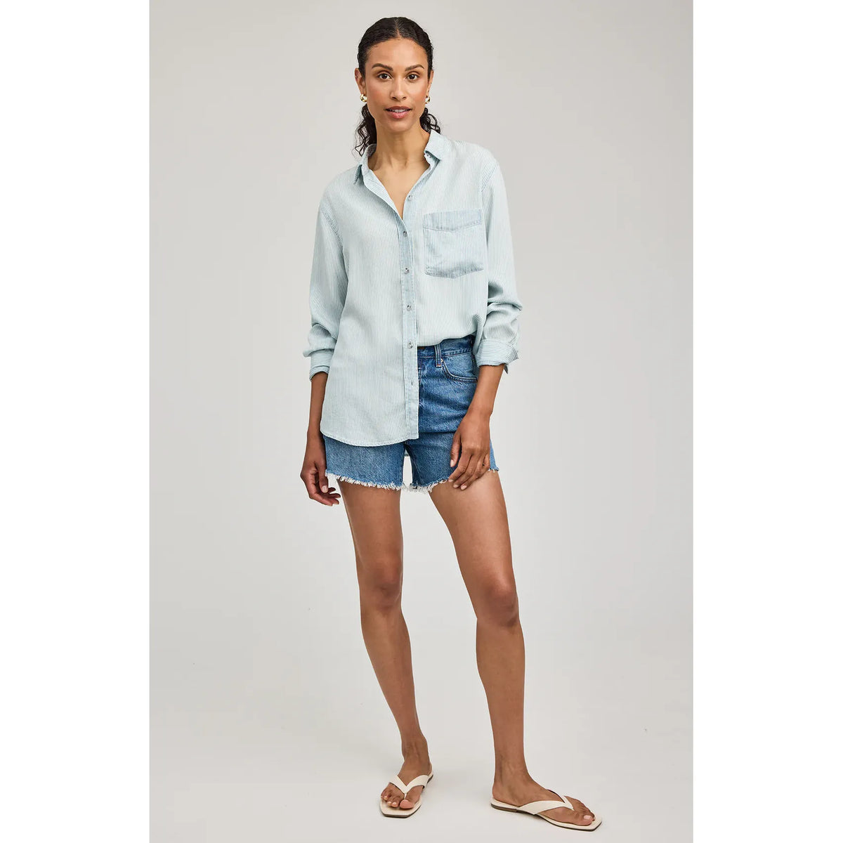 Pale blue Gentle Fawn Ozzy Button Down Shirt in 100% Tencel, washed texture, chest pocket, worn with denim shorts.
