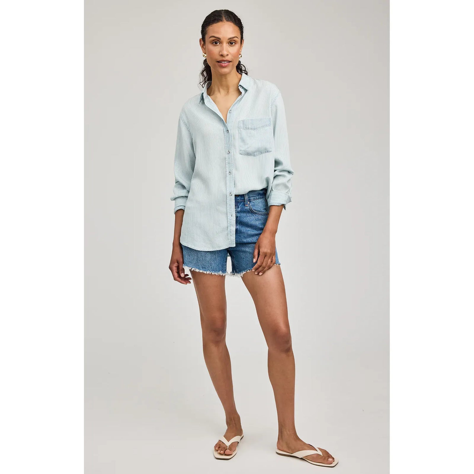 Pale blue Gentle Fawn Ozzy Button Down Shirt in 100% Tencel, washed texture, chest pocket, worn with denim shorts.