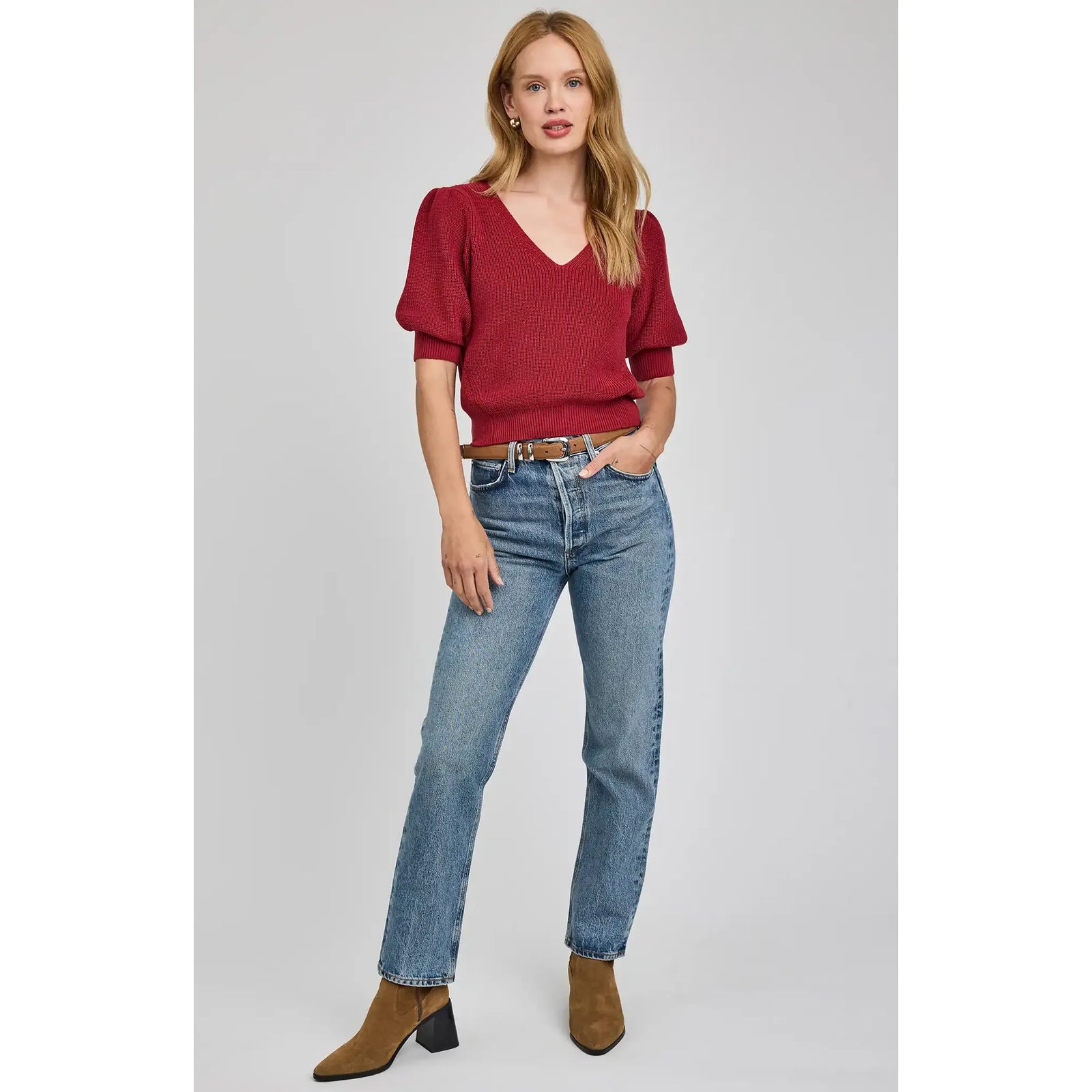 Gentle Fawn Phoebe V-Neck Sweater in red with puff sleeves, styled with jeans and brown boots.