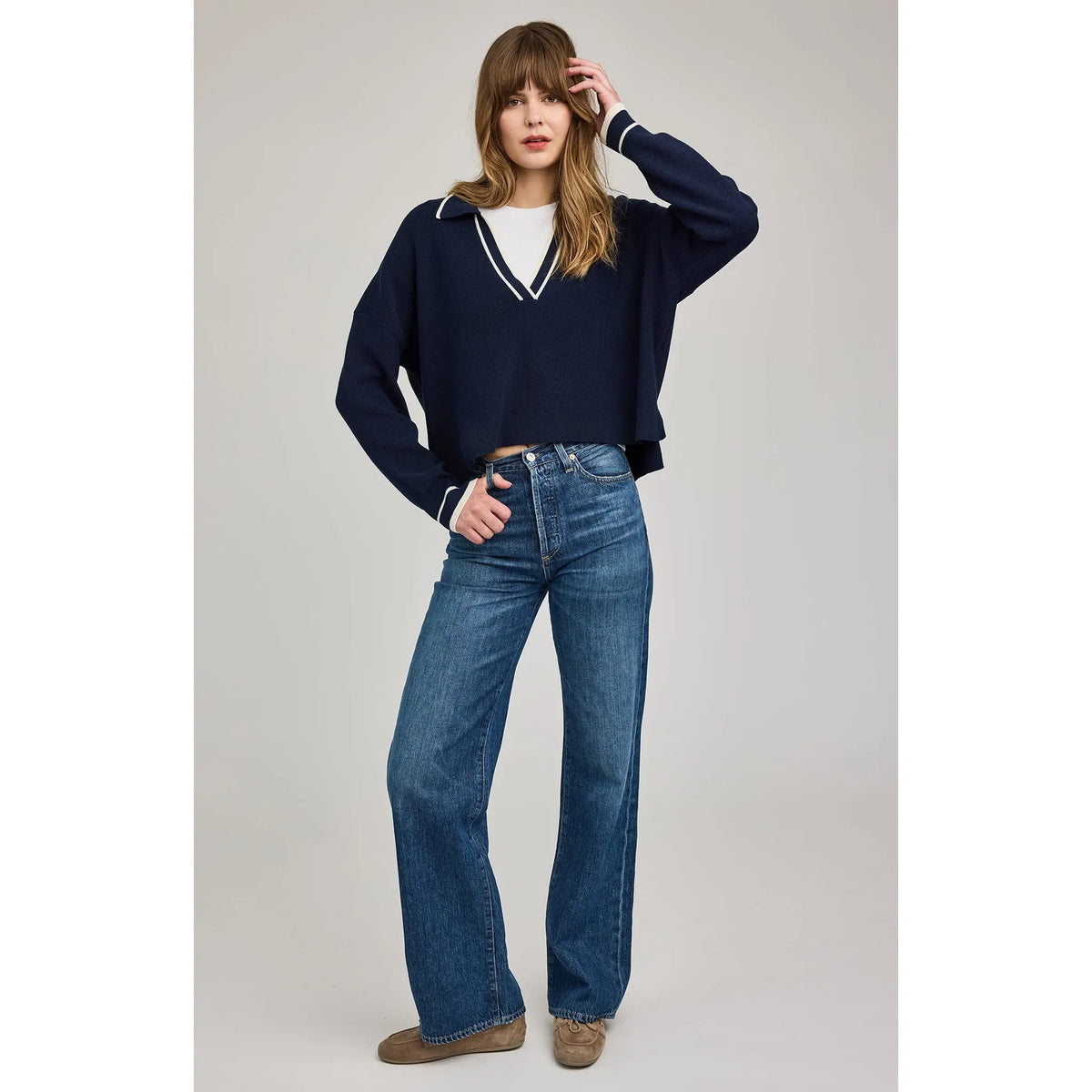 Gentle Fawn Tristan V-Neck Sweater in navy, oversized knit with white trim, worn with blue jeans.