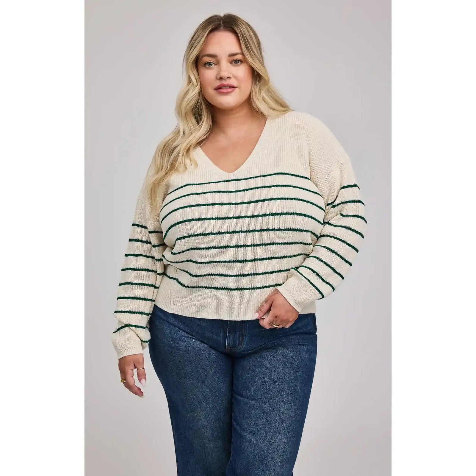 Gentle Fawn Tucker Pullover: cream knit with green stripes, relaxed fit on model wearing jeans.
