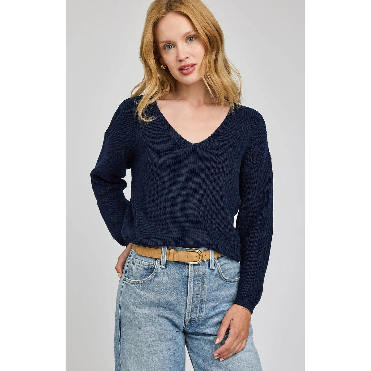 Gentle Fawn Tucker Pullover in a soft heathered knit with V-neck, paired with light-wash jeans and tan belt.