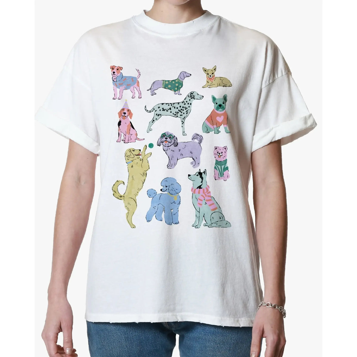 White oversized tee with a colorful collage of illustrated dogs across the front.