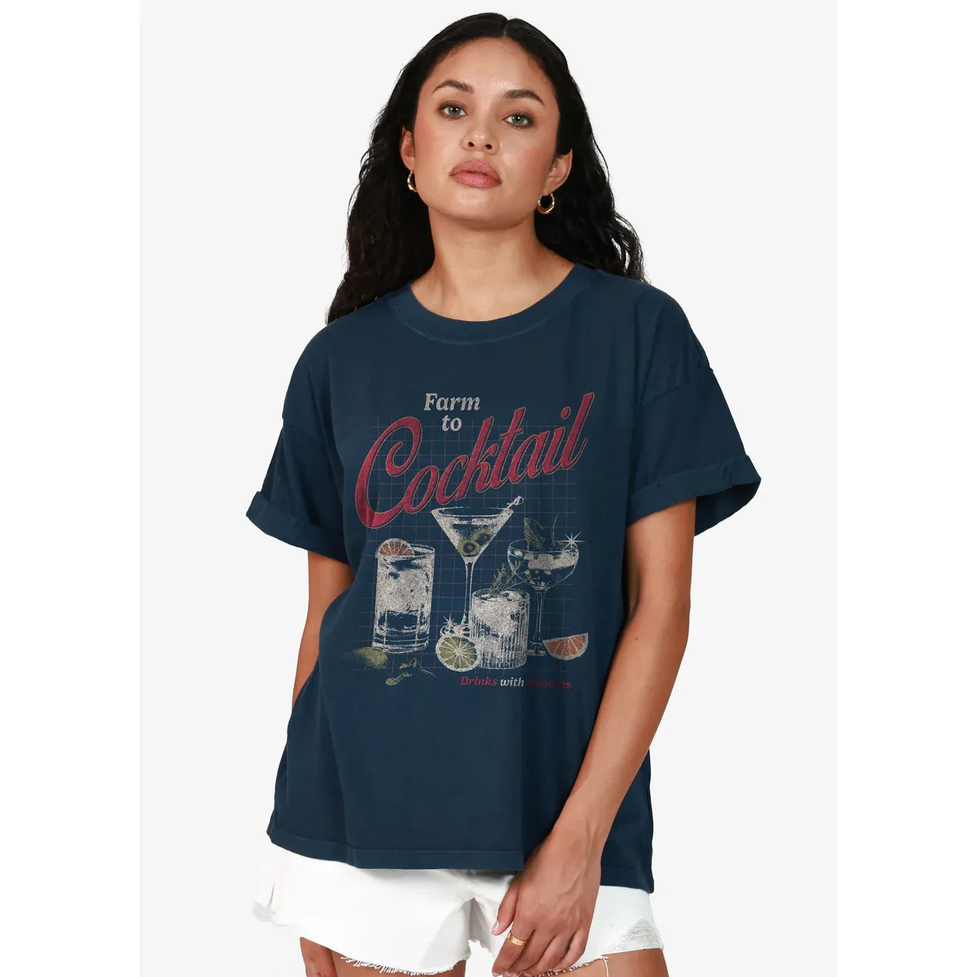 Woman wearing navy Farm to Cocktail Boyfriend Tee with rolled sleeves and drink-print graphic.