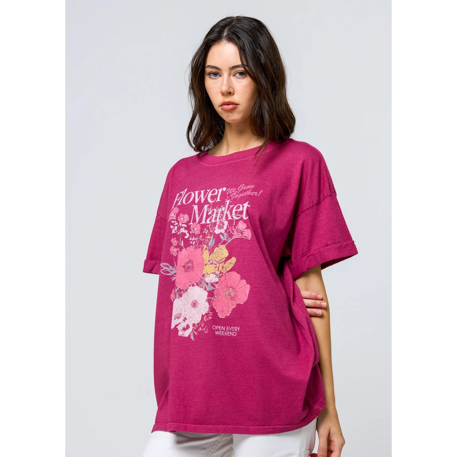 Girl wearing pink Flower Market graphic oversized boyfriend tee with bold floral print.