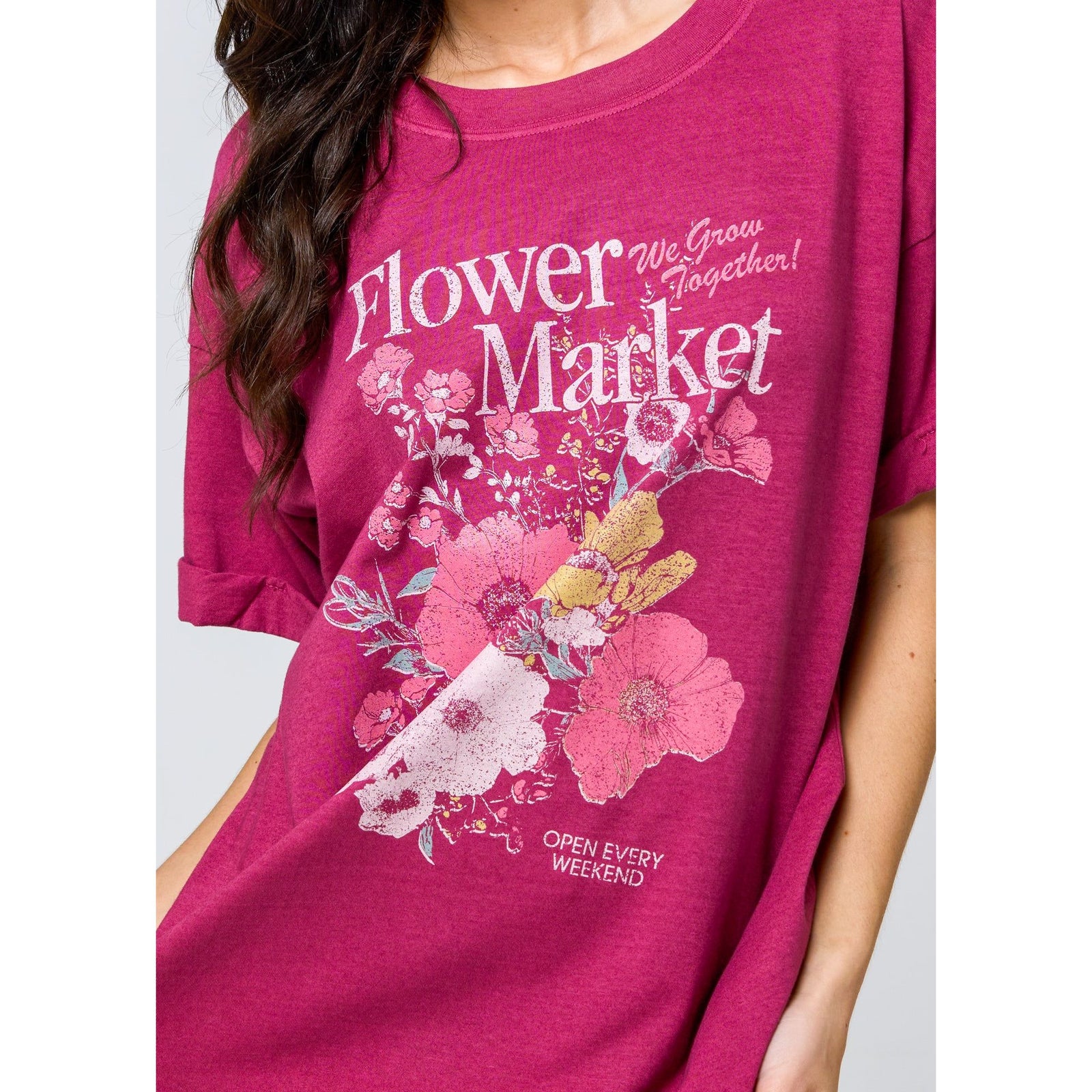 Girl wearing pink Flower Market graphic oversized boyfriend tee with bold floral print.
