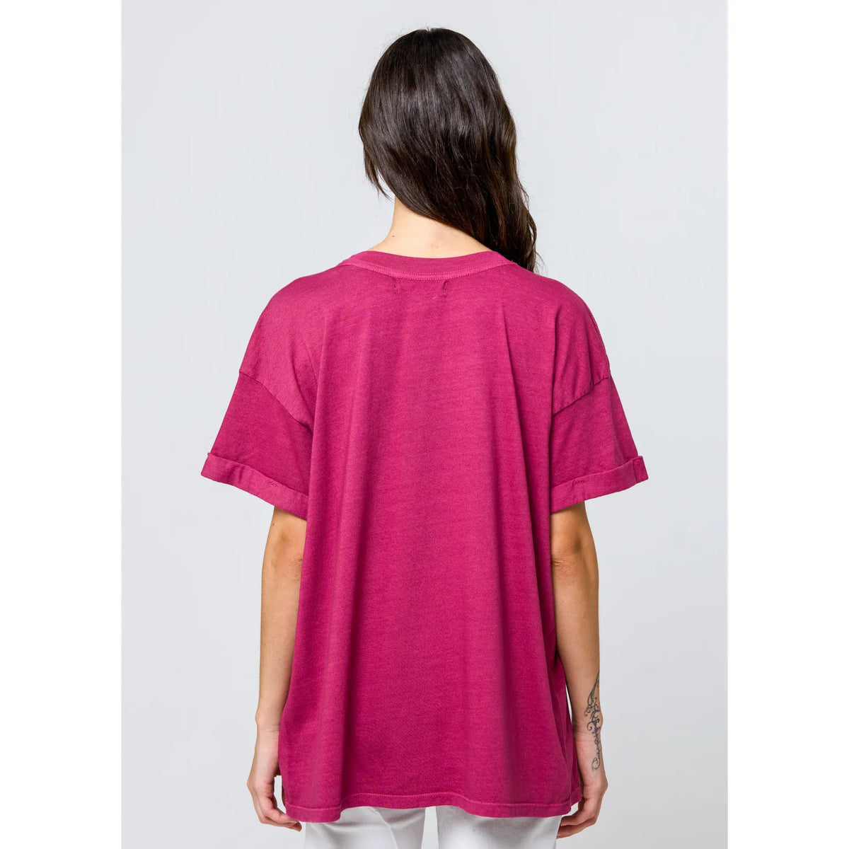 Back view of a girl wearing the pink pigment-dyed Girl Dangerous Flower Market Boyfriend Tee.