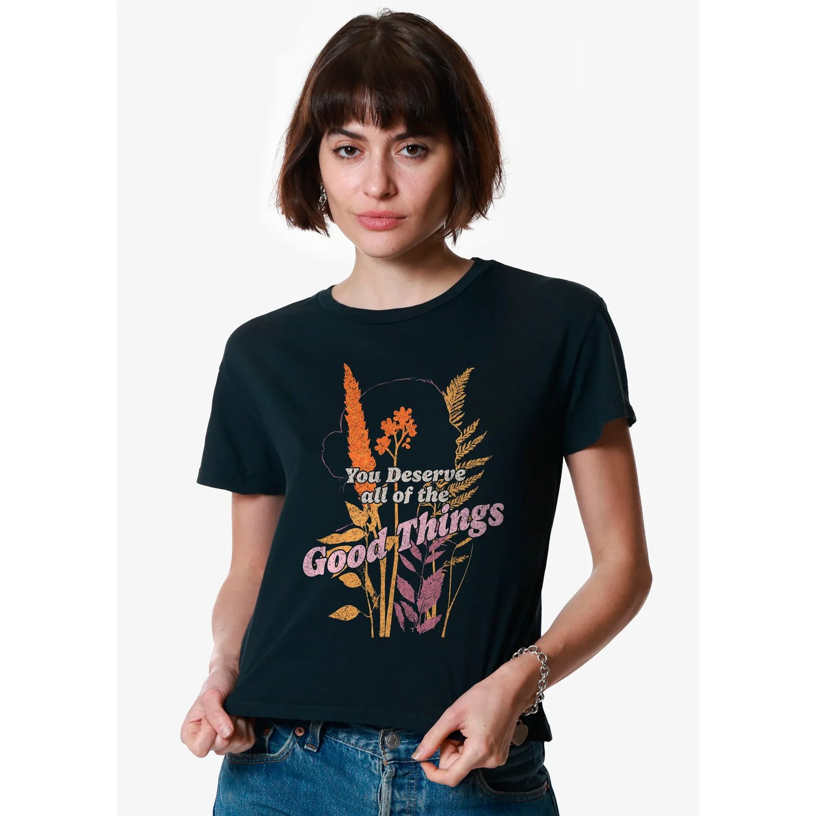Model wearing Girl Dangerous Good Things Classic Tee with colorful floral graphic on a dark shirt.