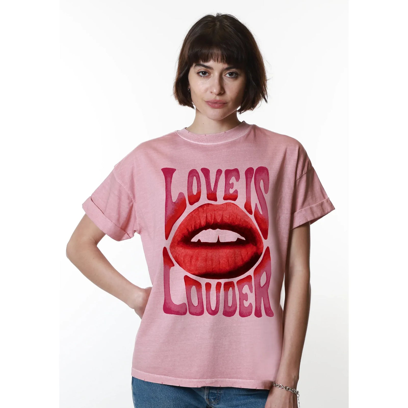 Pink oversized boyfriend tee with Love Is Louder lip graphic worn by a model.
