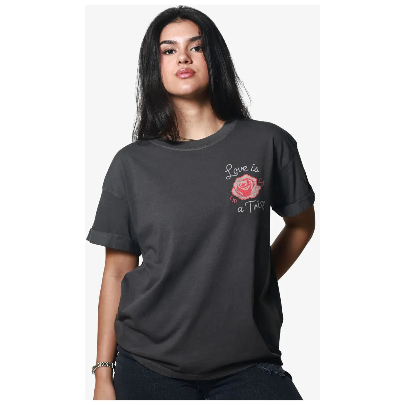 Stylish model showcasing the Girl Dangerous Love is a Trip Vintage Tee, featuring a relaxed fit and vibrant rose graphic.