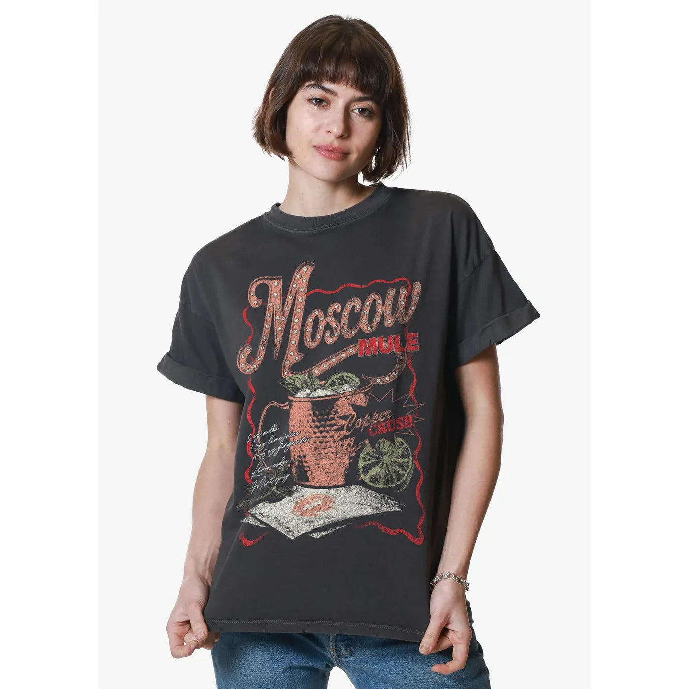 Model wearing black Girl Dangerous Moscow Mule Boyfriend Tee with rolled sleeves and vintage copper mug graphic.