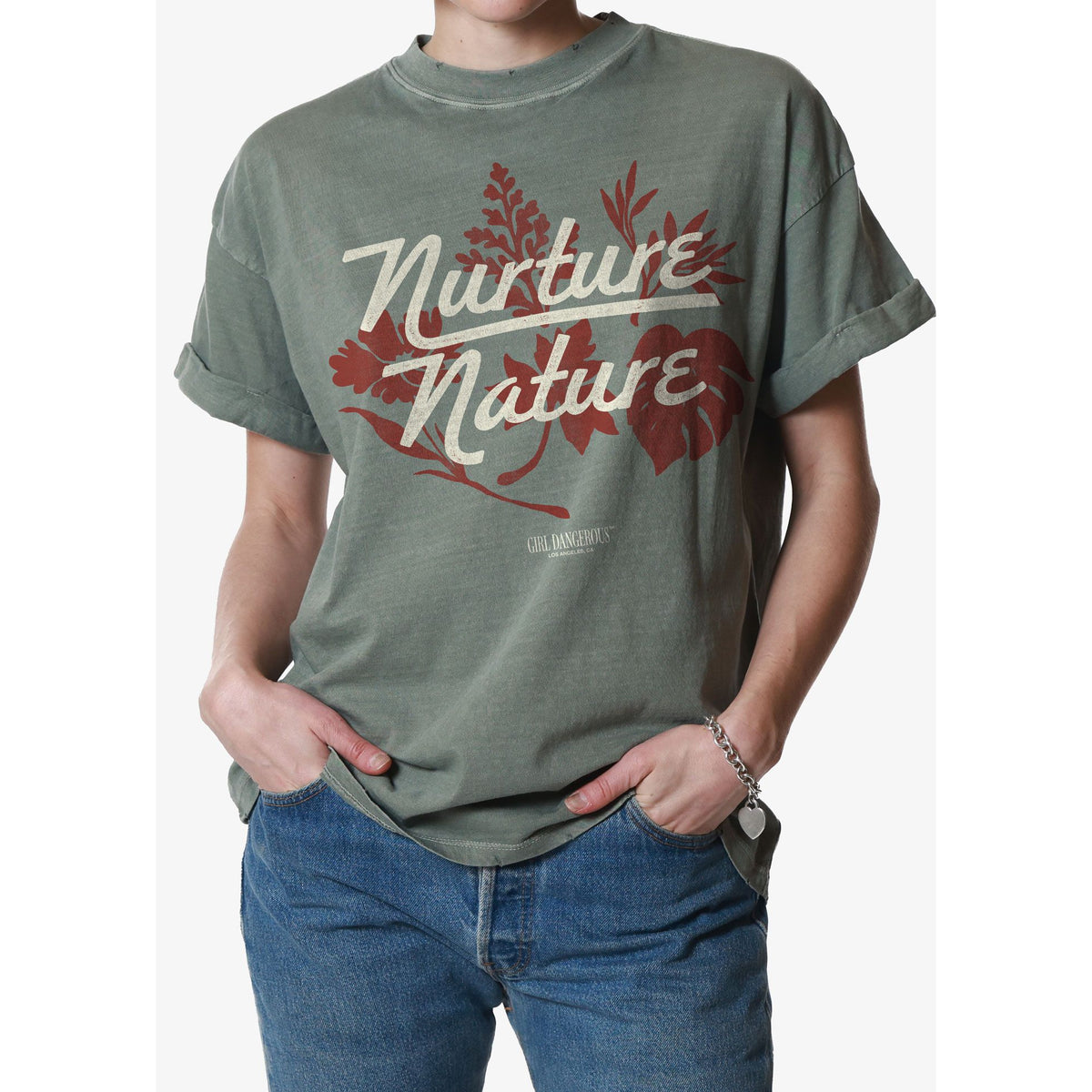 Girl Dangerous Nurture Nature Tee — model wearing vintage pigment-dyed cotton tee with red floral graphic.