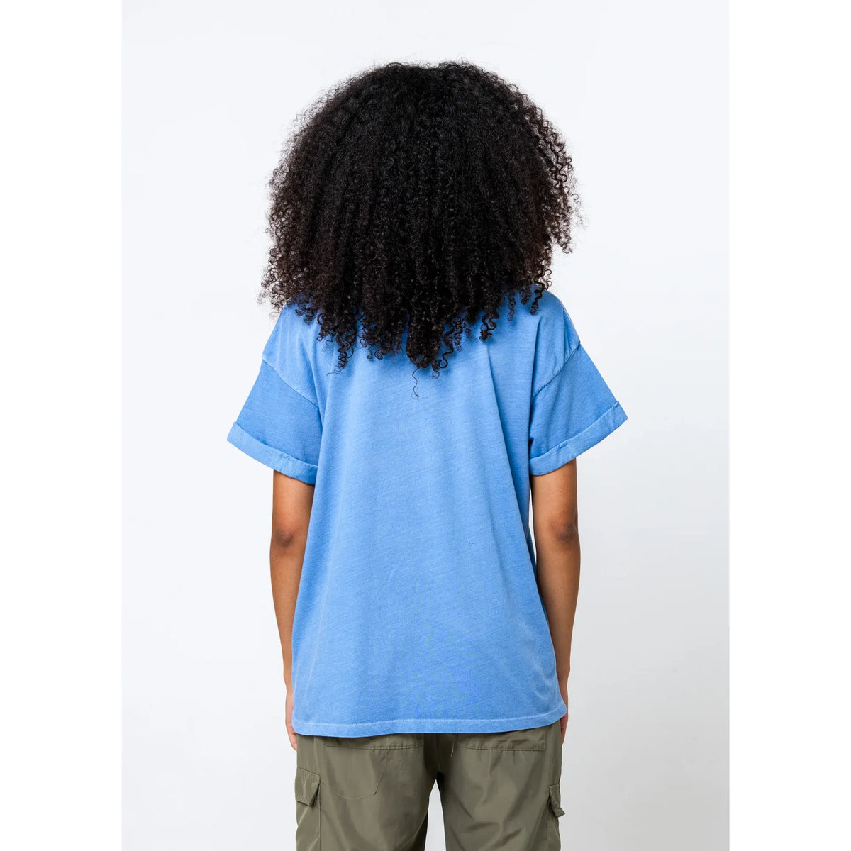 Back view of a girl with curly hair wearing a denim blue short-sleeve boyfriend tee.